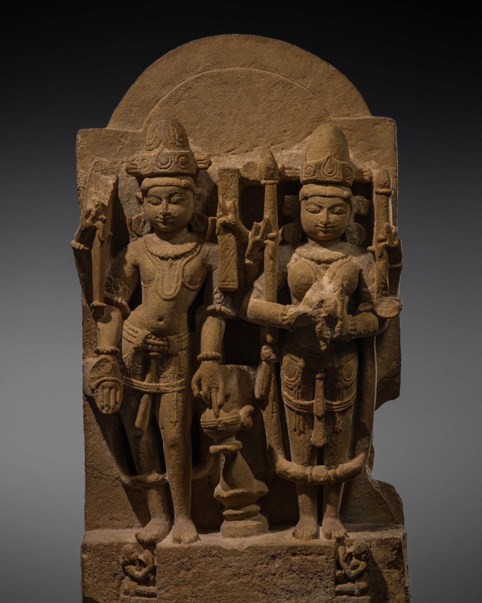 A BUFF SANDSTONE STELE OF A DIVINE COUPLE, MADHYA PRADESH OR RAJASTHAN, 10TH-12TH CENTURY (1 of 13)