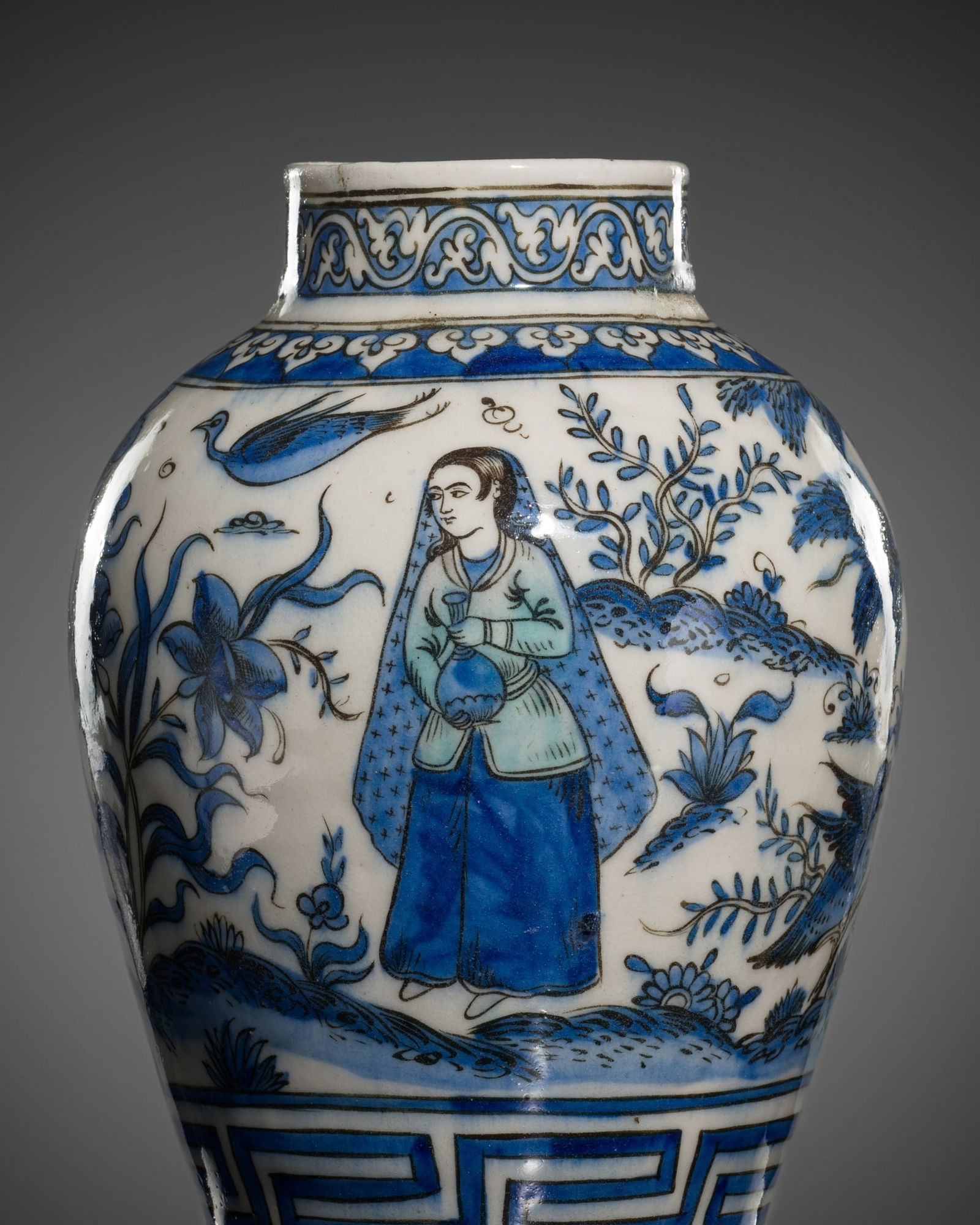 A FINELY PAINTED SAFAVID BLUE AND WHITE POTTERY JAR, IRAN, 17TH-18TH CENTURY: A FINELY PAINTED SAFAVID BLUE AND WHITE POTTERY JAR, IRAN, 17TH-18TH CENTURY The baluster body supported on a short, gently splayed foot with a recessed base and surmounted by a straight neck terminat