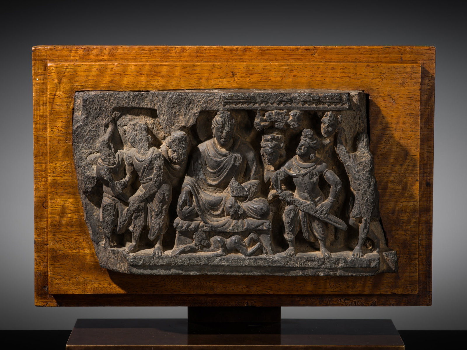 A GRAY SCHIST NARRATIVE PANEL DEPICTING TWO SCENES FROM THE ASSAULT OF MARA, ANCIENT REGION OF: A GRAY SCHIST NARRATIVE PANEL DEPICTING TWO SCENES FROM THE ASSAULT OF MARA, ANCIENT REGION OF GANDHARA Kushan period, 2nd-3rd century AD. Finely and deeply carved to depict Siddhartha Gautama at the