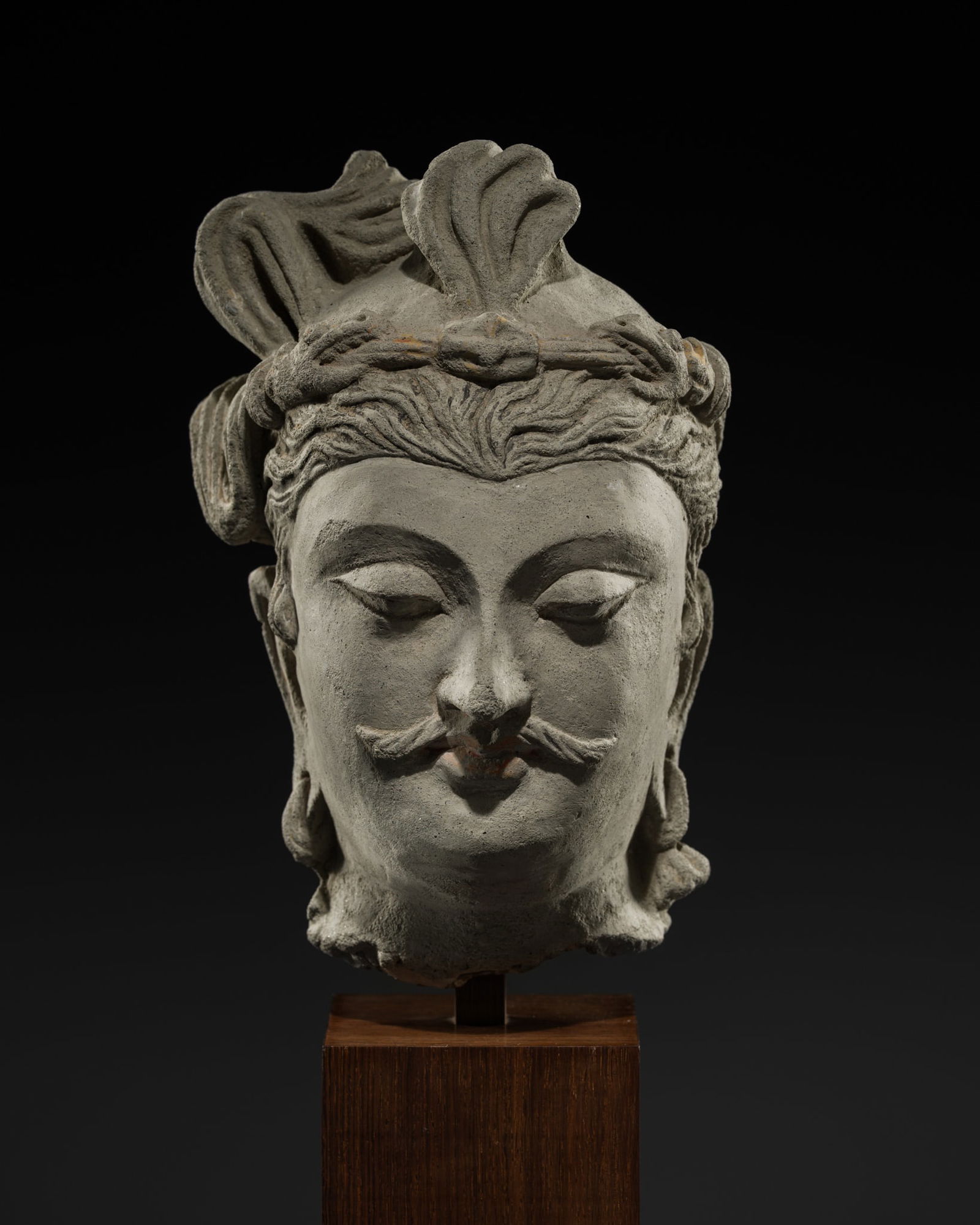 A STUCCO AND CLAY HEAD OF A BODHISATTVA, ANCIENT REGION OF GANDHARA, 3RD-5TH CENTURY: A STUCCO AND CLAY HEAD OF A BODHISATTVA, ANCIENT REGION OF GANDHARA, 3RD-5TH CENTURY Kushan period. Sensitively modeled, the oval face bearing a serene and meditative expression, defined by heavy-lidd