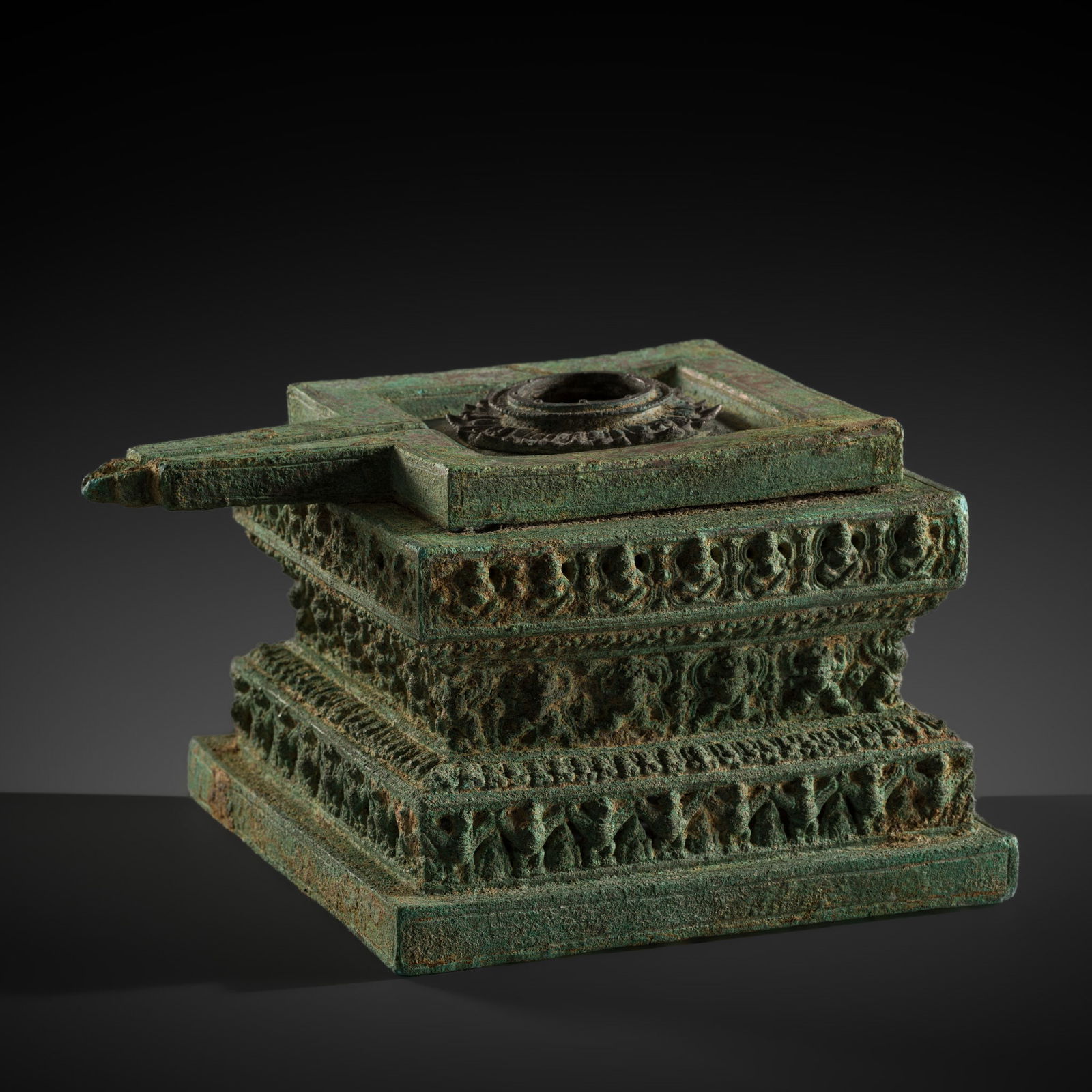 A LARGE AND EXTREMELY RARE BRONZE AND SILVER 'GARUDA' YONI, ANGKOR PERIOD: A LARGE AND EXTREMELY RARE BRONZE AND SILVER 'GARUDA' YONI, ANGKOR PERIOD Khmer Empire, 11th-13th century. Of square section and stepped waisted form. Three tiers are finely cast with bands of numerou