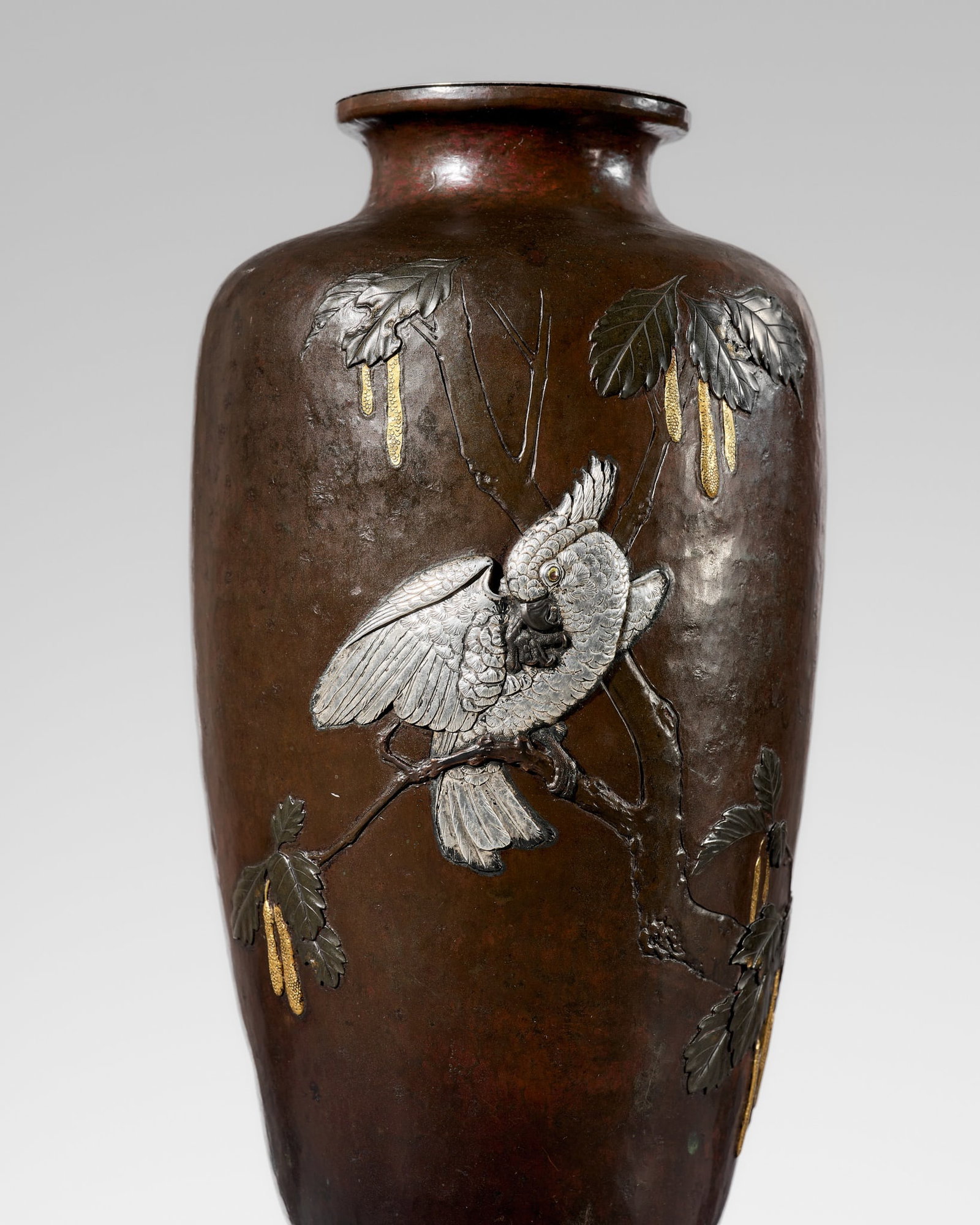 ROKKO: A SUPERB SILVER-INLAID BRONZE 'COCKATOO' VASE: ROKKO: A SUPERB SILVER-INLAID BRONZE 'COCKATOO' VASE By Rokko, sealed Rokko Japan, Meiji period (1868-1912) Of ovoid shape, gently tapering toward the short foot and surmounted by a waisted neck with 