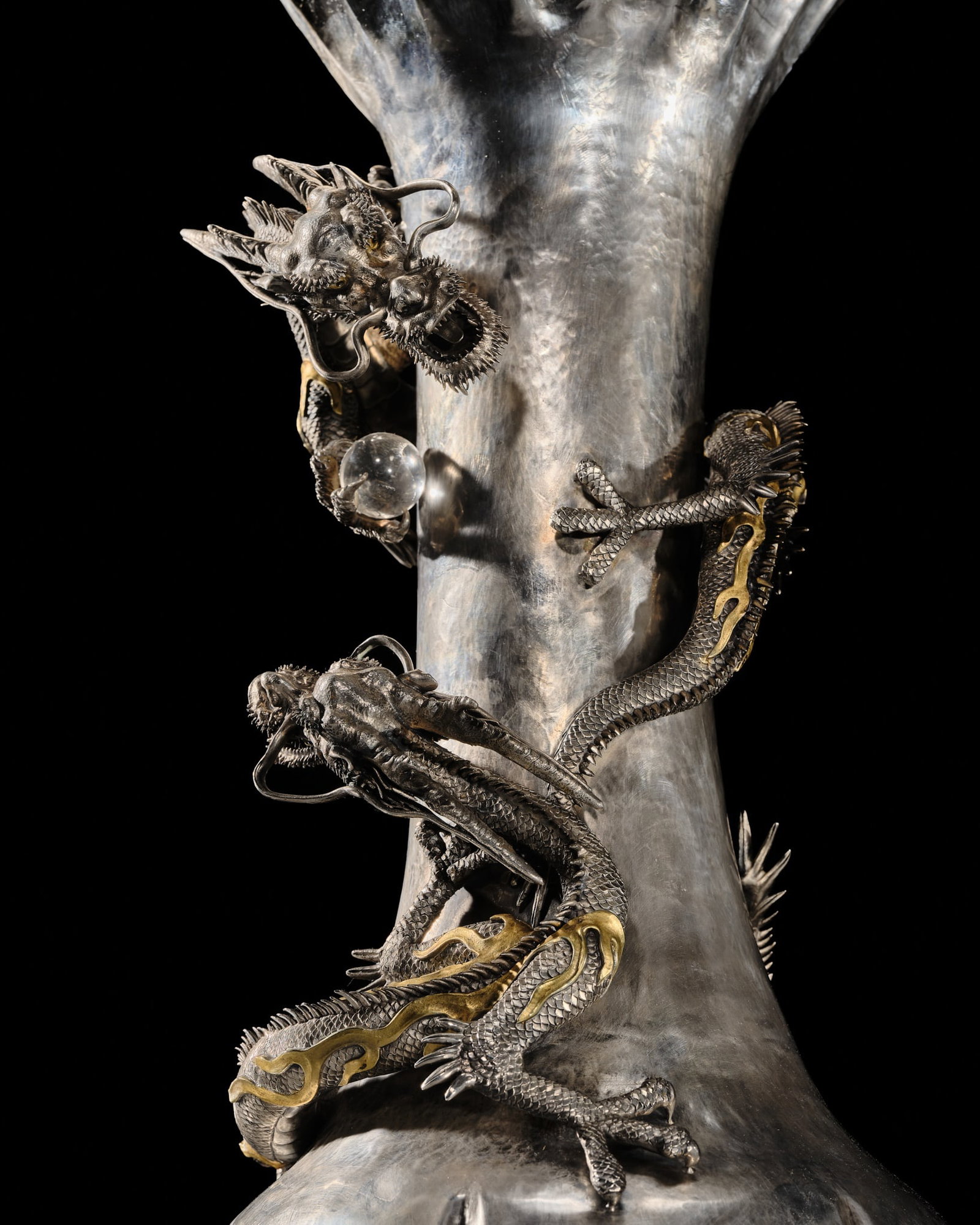 WATANABE: AN IMPRESSIVE AND VERY LARGE (53 CM) SILVER 'DRAGONS WITH CRYSTAL TAMA' VASE: WATANABE: AN IMPRESSIVE AND VERY LARGE (53 CM) SILVER 'DRAGONS WITH CRYSTAL TAMA' VASE By Watanabe, signed Watanabe sei Japan, c. 1900, Meiji period (1868-1912) Imposingly cast, this vase is of trumpe