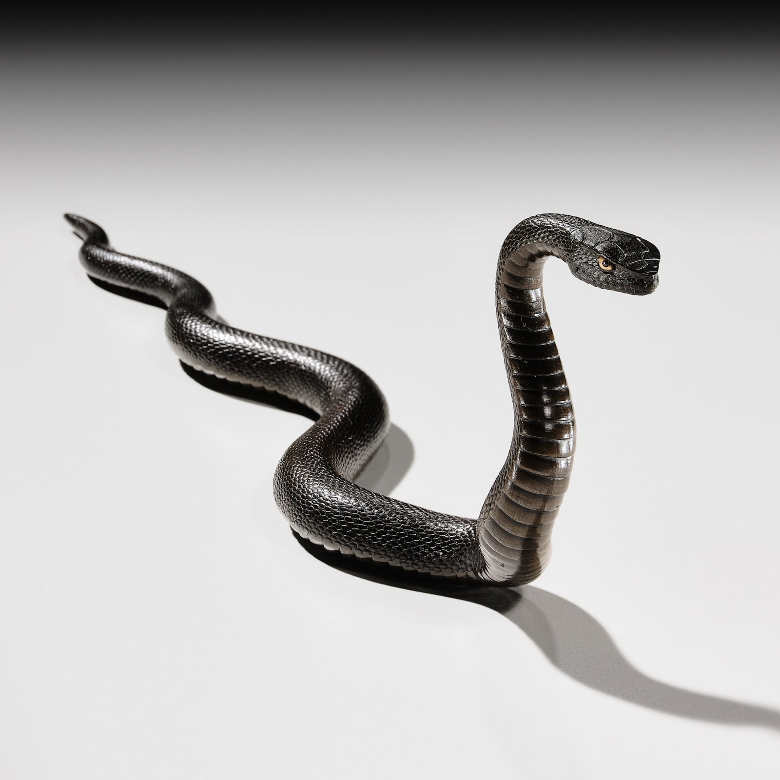 AN EXCEPTIONAL AND RARE BRONZE OKIMONO OF A SNAKE: AN EXCEPTIONAL AND RARE BRONZE OKIMONO OF A SNAKE Japan, Meiji period (1868-1912) Naturalistically cast in a sinuous, elongated form, the snake is shown with its body undulating across the ground whil