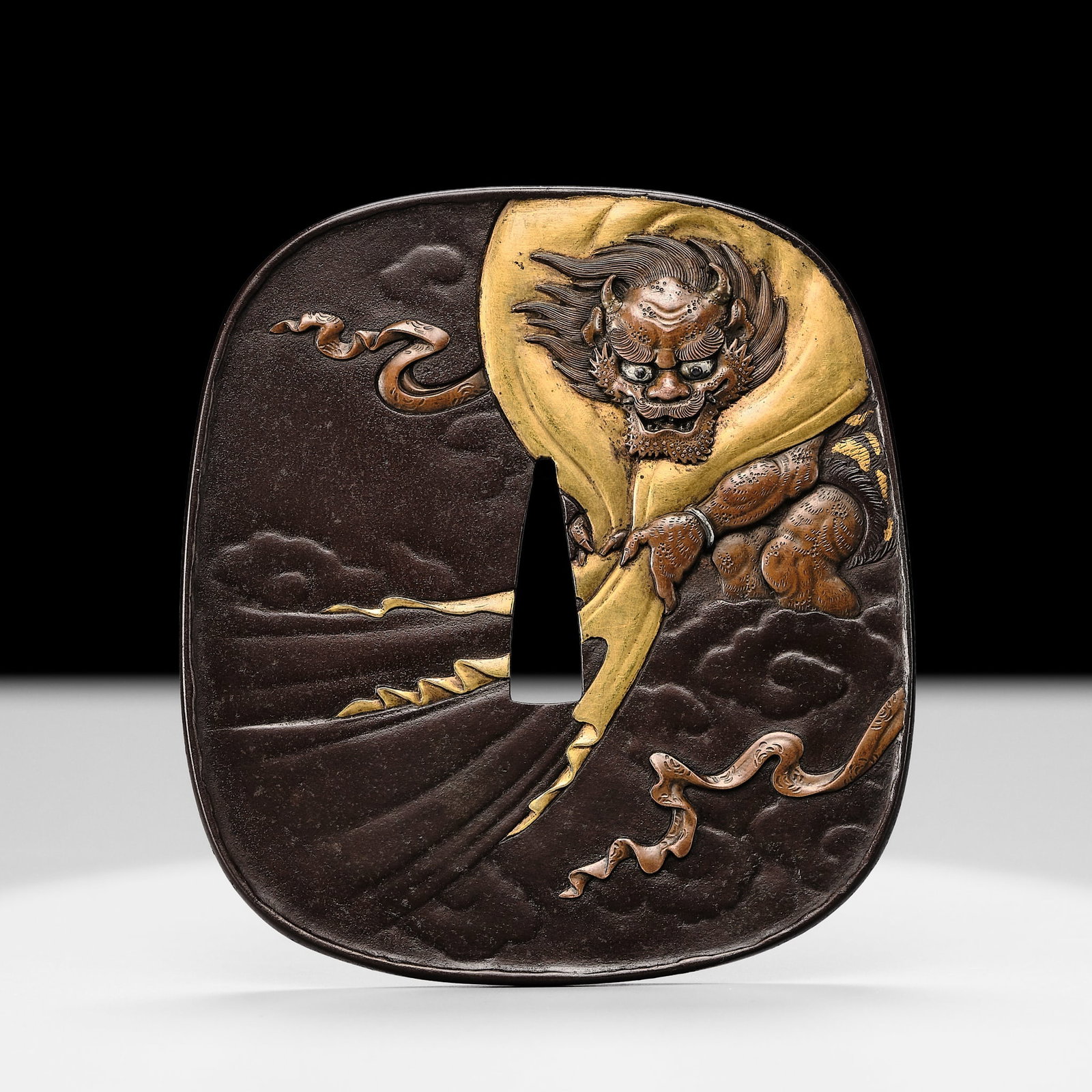 TAKUGYOKUSAI SADAMITSU: A SUPERB IRON 'FUJIN AND GEISHA' TSUBA (1 of 11)