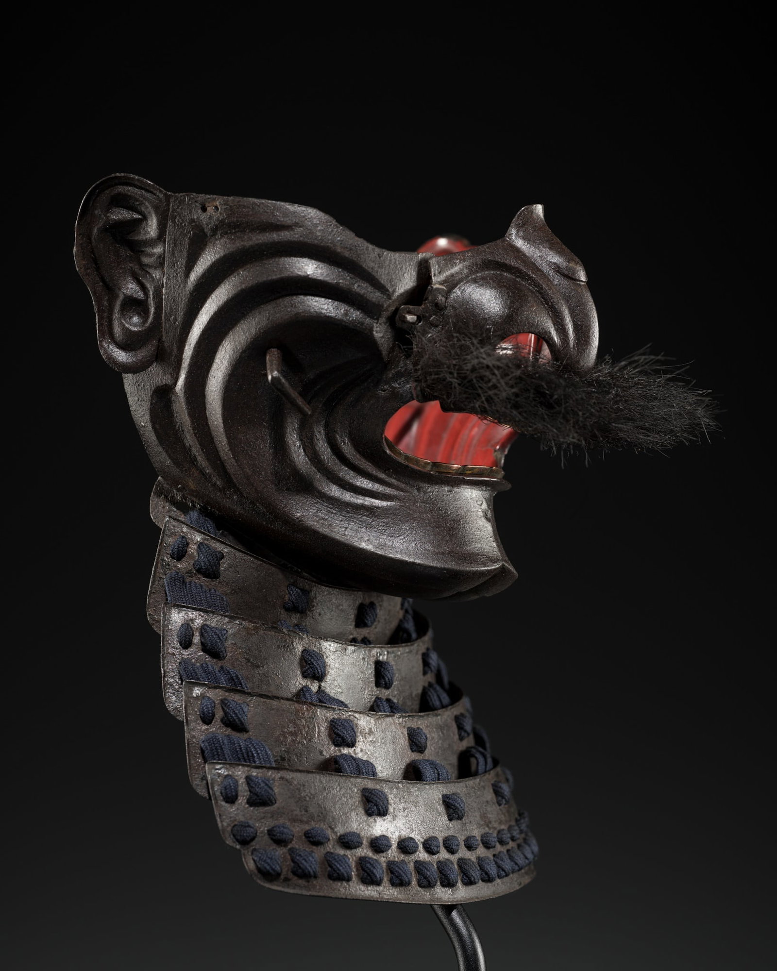 A LACQUERED IRON MENPO: A LACQUERED IRON MENPO Japan, 18th century, Edo period (1615-1868) An enpo-type menpo in the me no shita bo style, finely forged in one piece with a removable nose plate secured by turning pins, the f