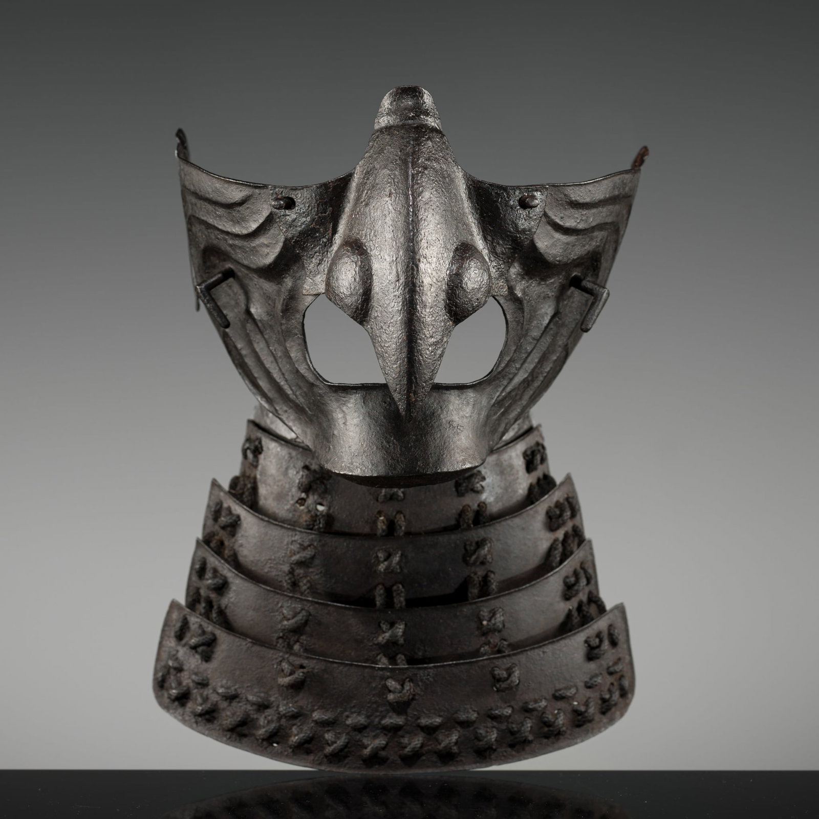 AN IRON KARASU-TENGU MENPO (FACE MASK): AN IRON KARASU-TENGU MENPO (FACE MASK) Japan, 18th century, Edo period (1615-1868) Finely cast and forged in five sections with a detachable nose plate secured by turning pins, designed with deeply em