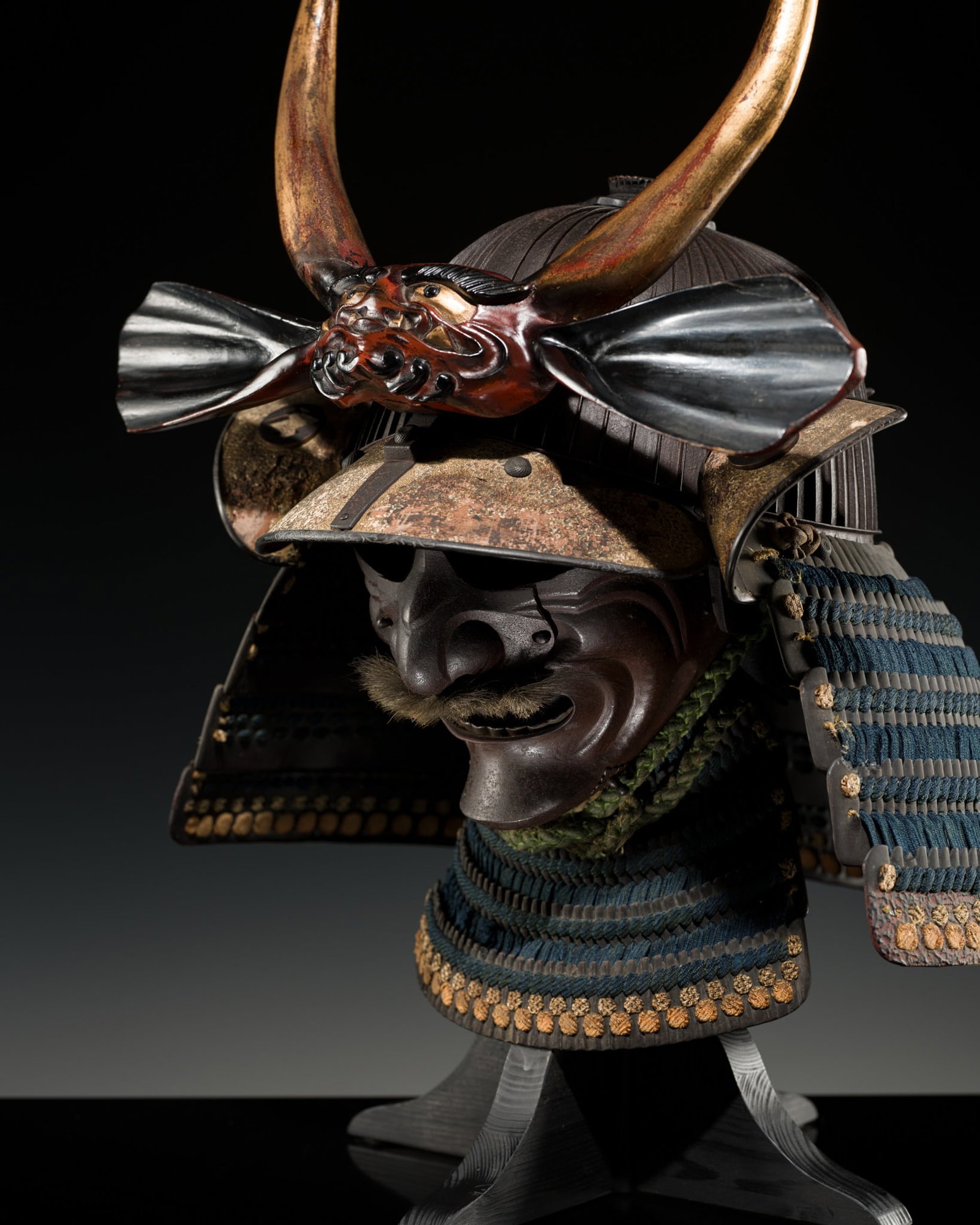 FUJIWARA IEHISA: A HARUTA SCHOOL SUJIBACHI KABUTO WITH ONI MAEDATE AND MATSUKAWA-BISHI MON, AND IRON: FUJIWARA IEHISA: A HARUTA SCHOOL SUJIBACHI KABUTO WITH ONI MAEDATE AND MATSUKAWA-BISHI MON, AND IRON MENPO The kabuto by Fujiwara Iehisa, signed Fujiwara Iehisa Japan, 17th century, early Edo period (