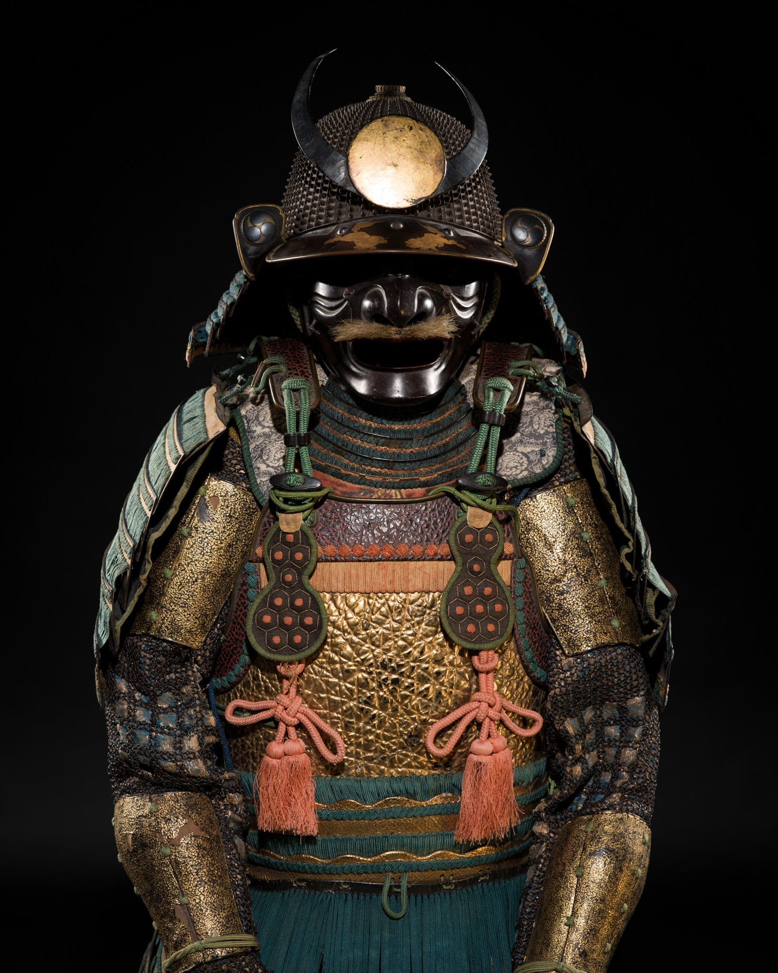 AN OKEGAWA NIMAI-DO GUSOKU (TWO-PIECE CUIRASS ARMOR) AND A KOBOSHI KABUTO: AN OKEGAWA NIMAI-DO GUSOKU (TWO-PIECE CUIRASS ARMOR) AND A KOBOSHI KABUTO Japan, 17th-18th century, Edo period (1615-1868) The predominantly gilt-lacquered components laced in turquoise, mounted