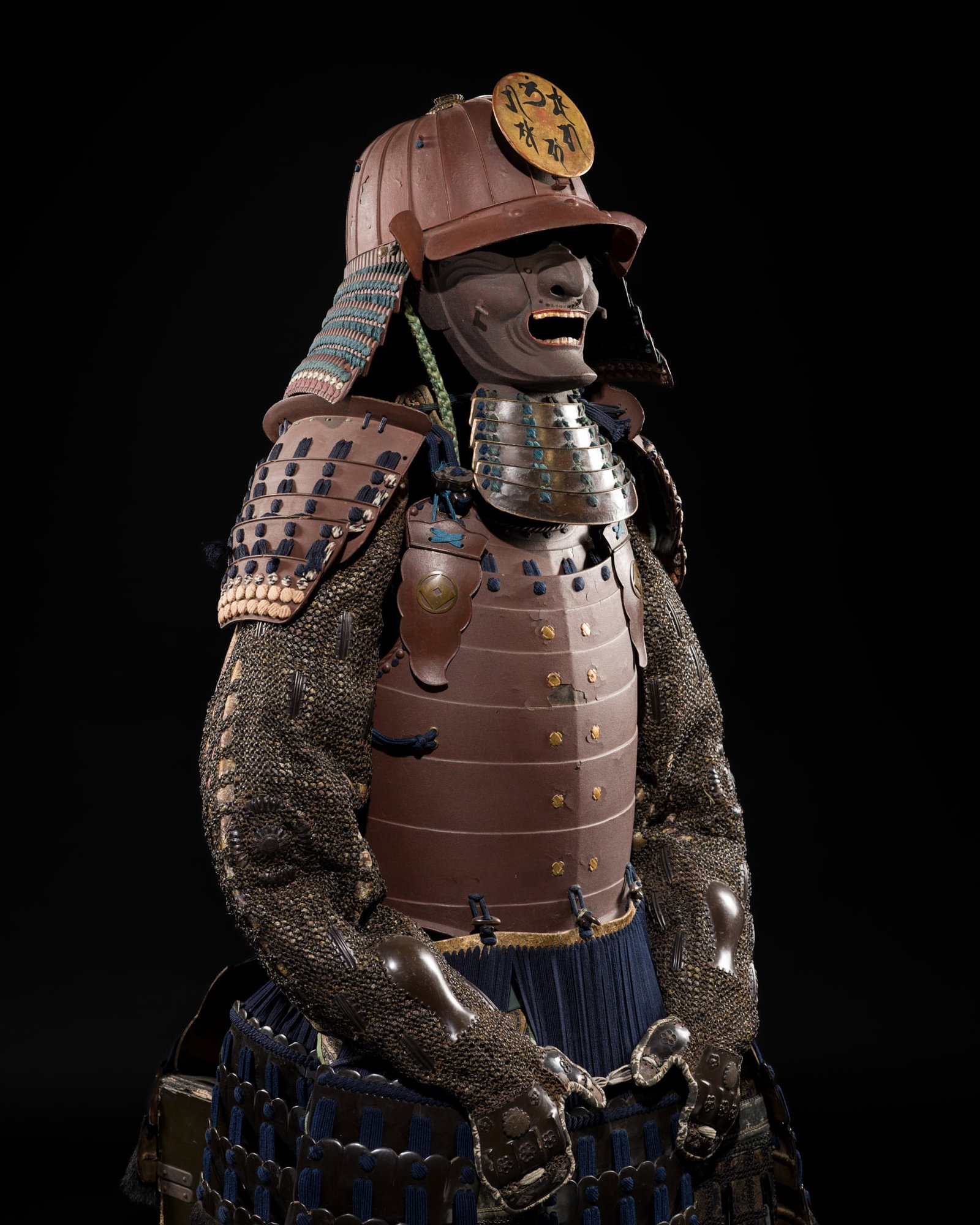 AN OKEGAWA NIMAI-DO GUSOKU (TWO-PIECE CUIRASS ARMOR): AN OKEGAWA NIMAI-DO GUSOKU (TWO-PIECE CUIRASS ARMOR) Japan, 18th-19th century, Edo period (1615-1868) The predominantly lacquered components laced in blue, mounted on silk brocade, and fitted wi