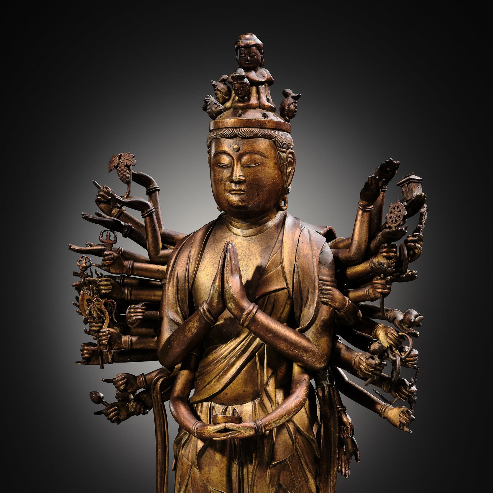 A HIGHLY IMPORTANT AND EXCEEDINGLY RARE GILT-BRONZE FIGURE OF SENJU KANNON, THE THOUSAND-ARMED AND: A HIGHLY IMPORTANT AND EXCEEDINGLY RARE GILT-BRONZE FIGURE OF SENJU KANNON, THE THOUSAND-ARMED AND ELEVEN-HEADED AVALOKITESHVARA, C. 1300-1450 Japan, c. 1300-1450, late Kamakura (1185-1333) to early M