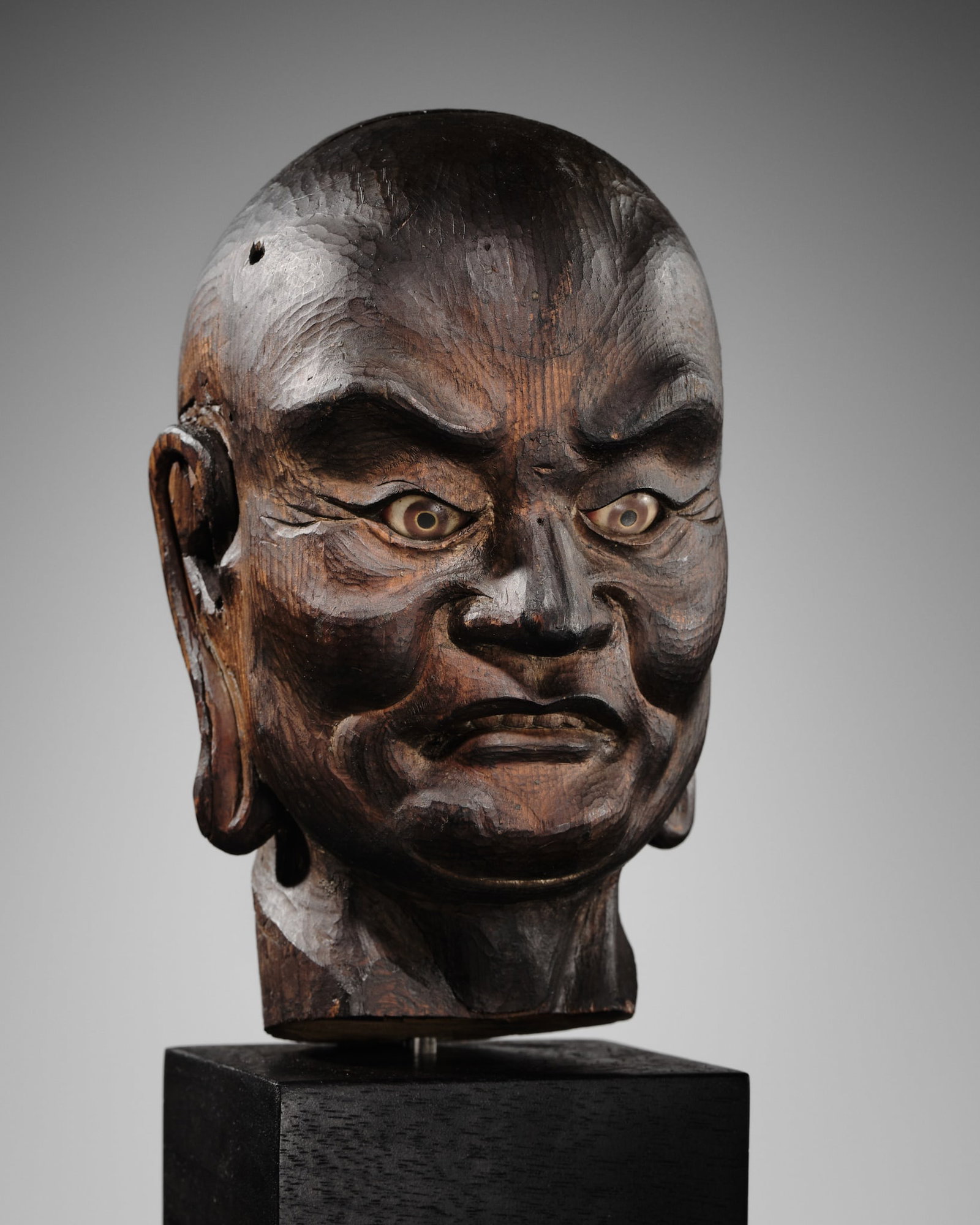 A CARVED WOOD HEAD OF A RAKAN, KAMAKURA PERIOD: A CARVED WOOD HEAD OF A RAKAN, KAMAKURA PERIOD Japan, 14th century, Kamakura period (1185-1333) From a yosegi-zukuri constructed figure, naturalistically carved as the head of a rakan with elongated e