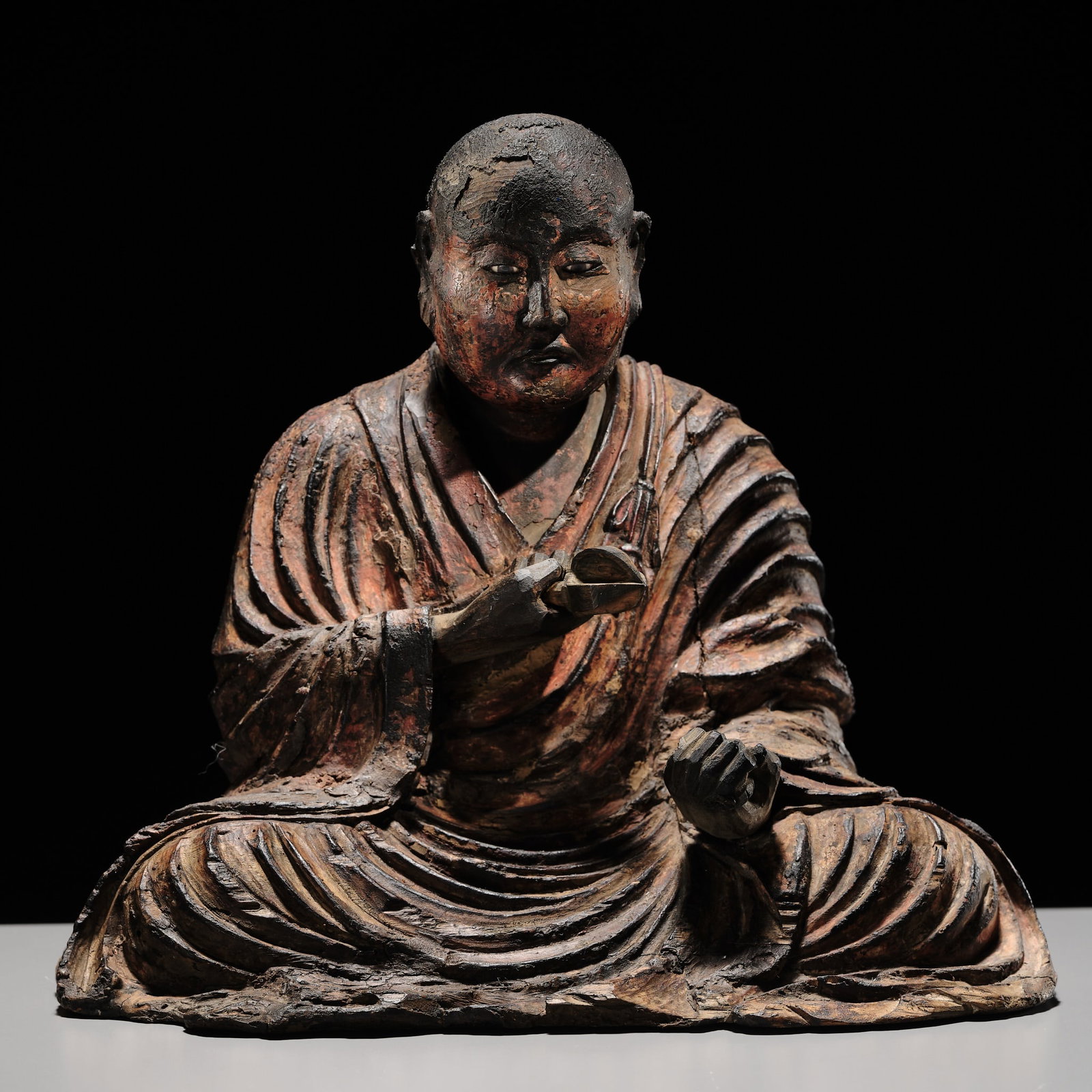 A FINE AND RARE LACQUERED WOOD FIGURE OF KUKAI, MUROMACHI PERIOD: A FINE AND RARE LACQUERED WOOD FIGURE OF KUKAI, MUROMACHI PERIOD Japan, 14th-16th century, Muromachi period (1333-1573) The yosegi-zukuri figure is carved seated in a meditative pose, the left h