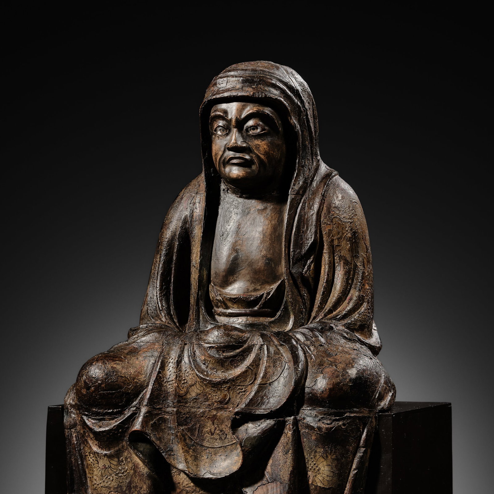 A LACQUERED WOOD FIGURE OF DARUMA, 16TH CENTURY: A LACQUERED WOOD FIGURE OF DARUMA, 16TH CENTURY Japan, 16th century, late Muromachi (1333-1573) to Momoyama period (1573-1615) Of yosegi (joined) construction, well carved to depict Daruma (Bodhidharm