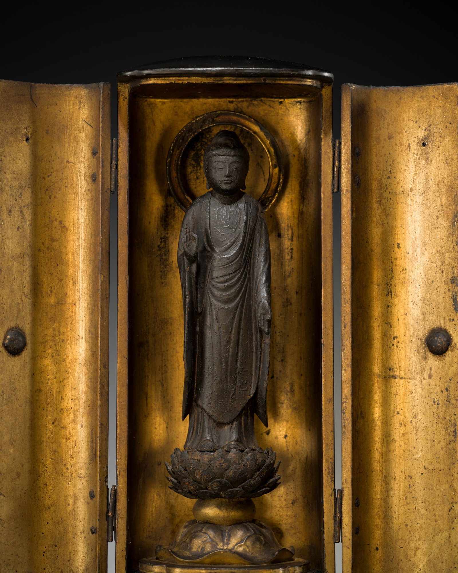 A LACQUER ZUSHI (PORTABLE SHRINE) CONTAINING AN EARLY WOOD FIGURE OF AMIDA NYORAI, HEIAN PERIOD: A LACQUER ZUSHI (PORTABLE SHRINE) CONTAINING AN EARLY WOOD FIGURE OF AMIDA NYORAI, HEIAN PERIOD Japan, the figure 11th-12th century, Heian period (794-1185), the shrine Edo period (1615-1868) Finely c