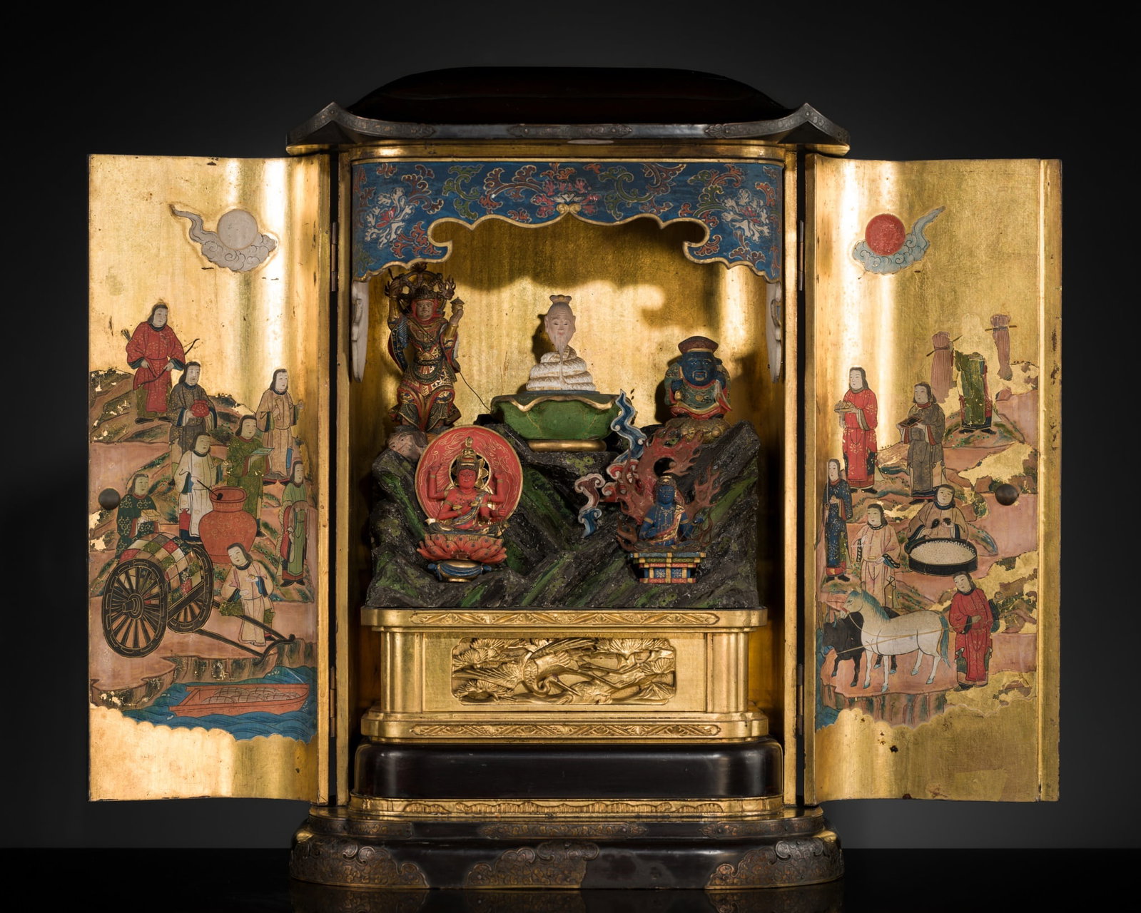 A RARE AND IMPRESSIVE LACQUER ZUSHI (PORTABLE SHRINE) WITH FIVE DEITIES, 18TH CENTURY: A RARE AND IMPRESSIVE LACQUER ZUSHI (PORTABLE SHRINE) WITH FIVE DEITIES, 18TH CENTURY Japan, 18th century, Edo period (1615-1868) The shrine opens to reveal a dynamic rocky landscape populated by five