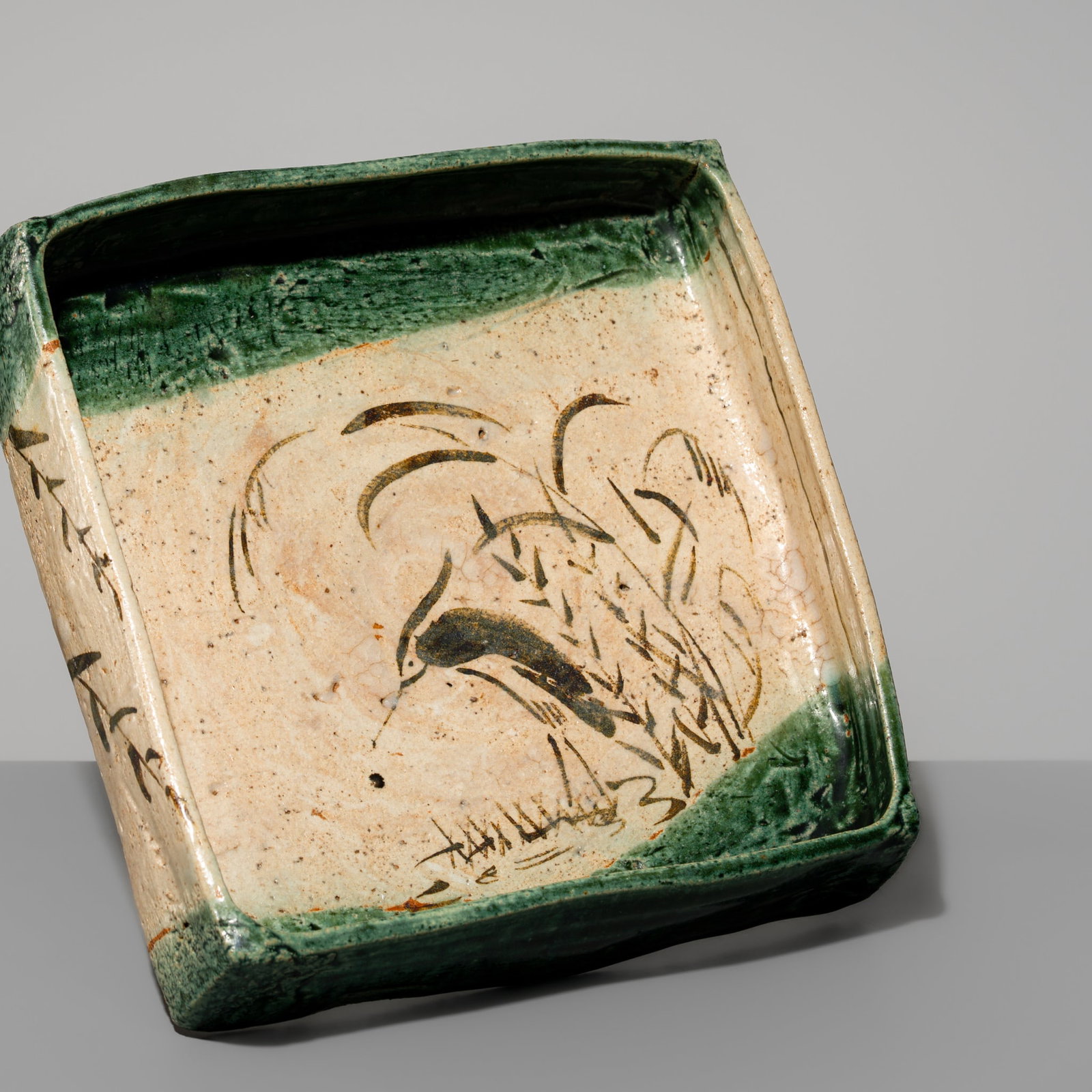 A VIVID AO-ORIBE CERAMIC 'HERON AMID REEDS' SQUARE MUKOZUKE (FOOD SERVING DISH): A VIVID AO-ORIBE CERAMIC 'HERON AMID REEDS' SQUARE MUKOZUKE (FOOD SERVING DISH) Japan, late Edo period (1615-1868) Boldly modeled, this rectangular dish features a flat base and straight sides. The su