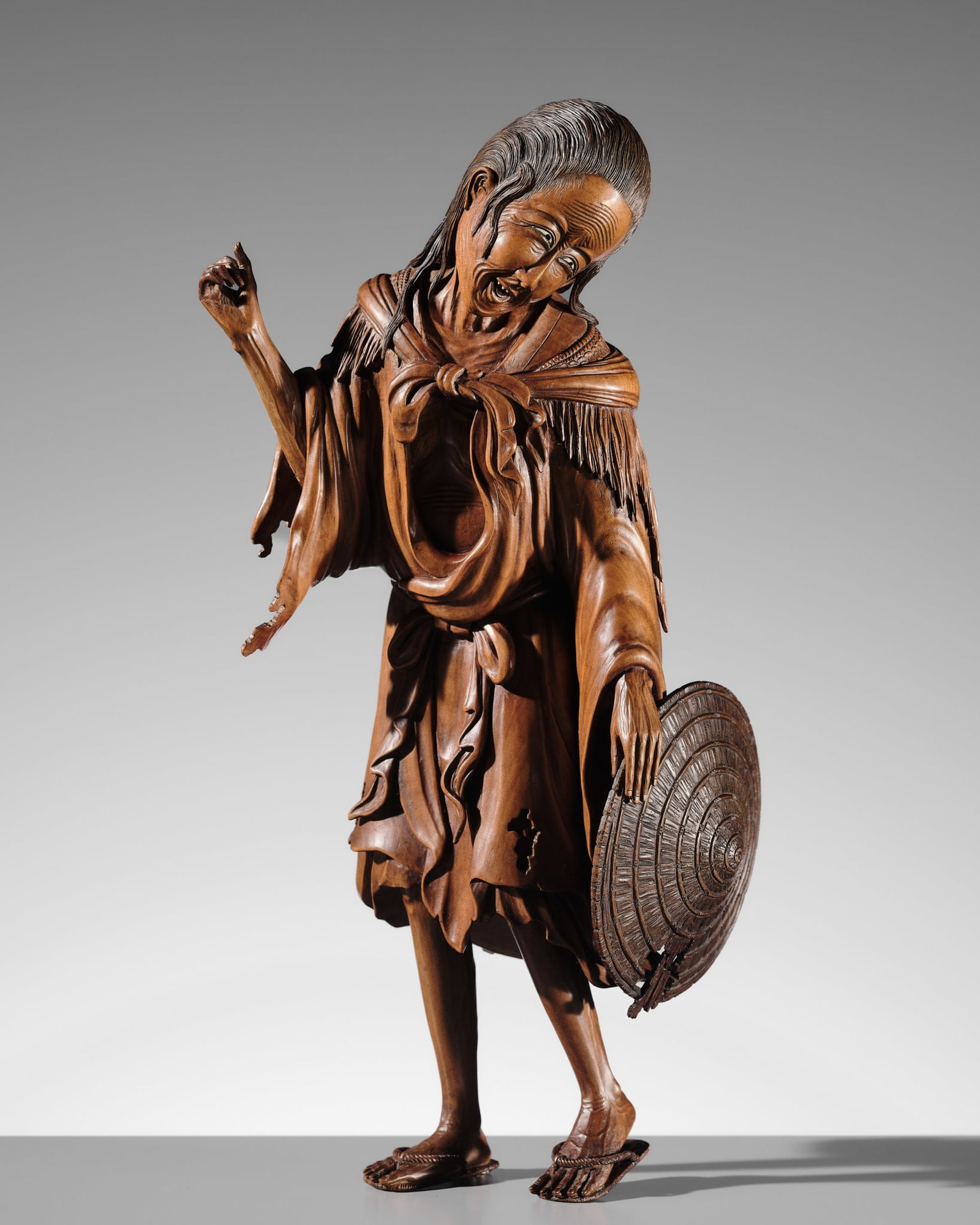 A FINE WOOD OKIMONO OF ONO NO KOMACHI: A FINE WOOD OKIMONO OF ONO NO KOMACHI Japan, late 19th-early 20th century, Meiji period (1868-1912) Finely carved to depict Ono no Komachi, shown as an aged woman standing in a dynamic, slightly