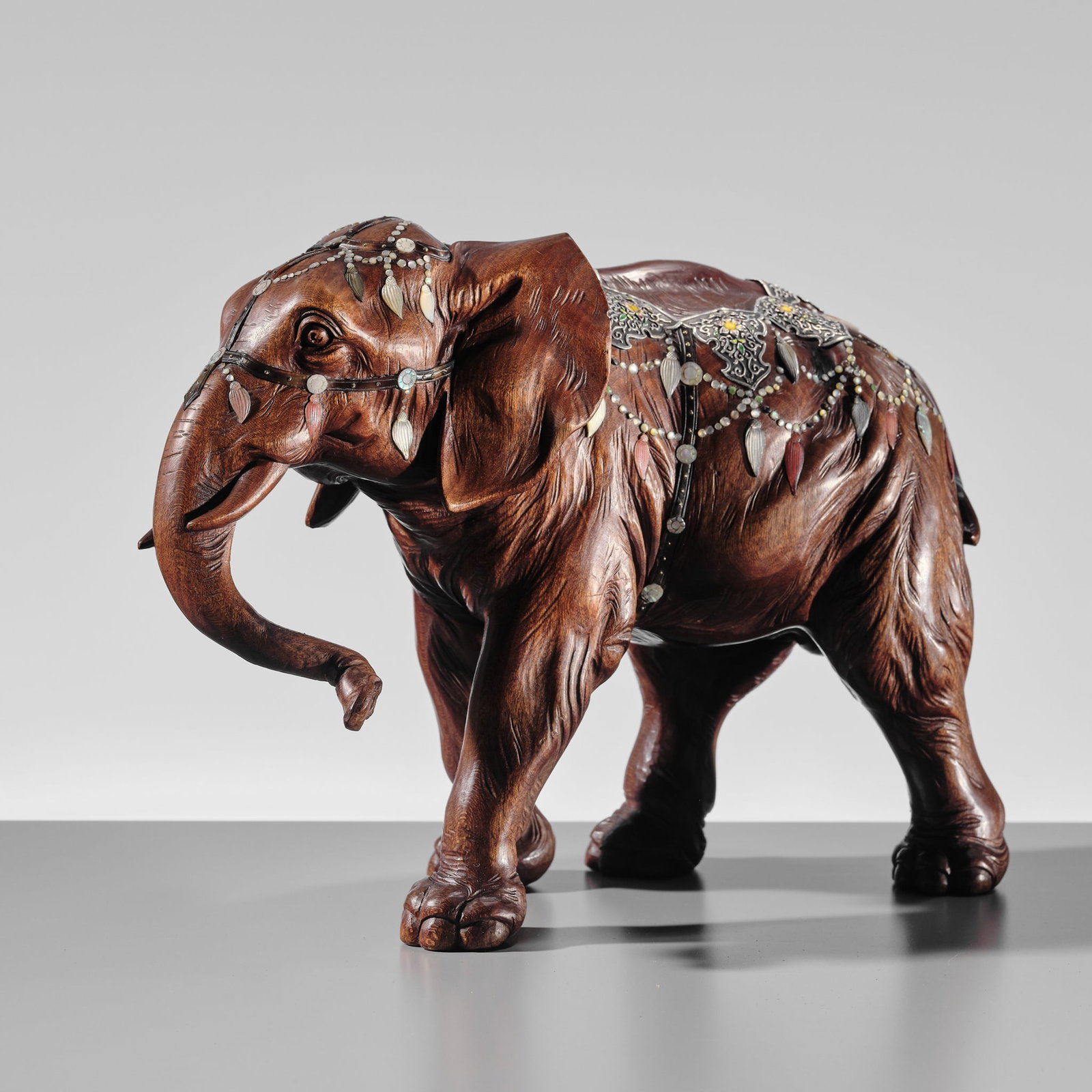 MITSUTAKE: A VERY FINE SHIBAYAMA-STYLE INLAID WOOD 'CAPARISONED ELEPHANT' OKIMONO: MITSUTAKE: A VERY FINE SHIBAYAMA-STYLE INLAID WOOD 'CAPARISONED ELEPHANT' OKIMONO By Goto Mitsutake, signed Mitsutake koku Japan, early 20th century, Meiji (1868-1912) to Taisho period (1912-1926) Nat