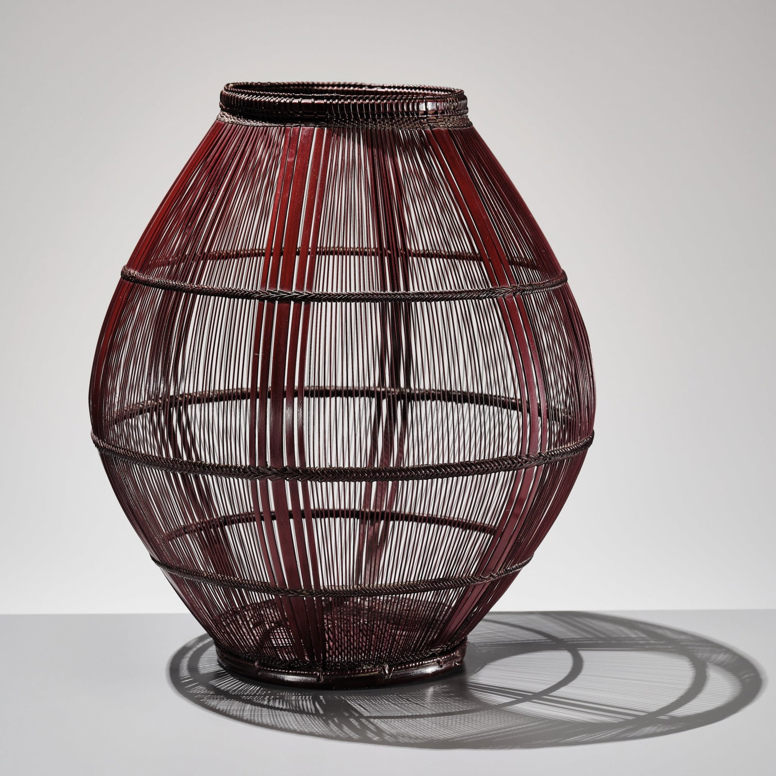 MAEDA CHIKUBOSAI II: A LACQUER BAMBOO AND RATTAN HANAKAGO (FLOWER BASKET): MAEDA CHIKUBOSAI II: A LACQUER BAMBOO AND RATTAN HANAKAGO (FLOWER BASKET) By Maeda Chikubosai II (1917-2003), signed Chikubosai kore o tsukuru Japan, c. 1990s Elegantly woven in a rounded, ovoid form,