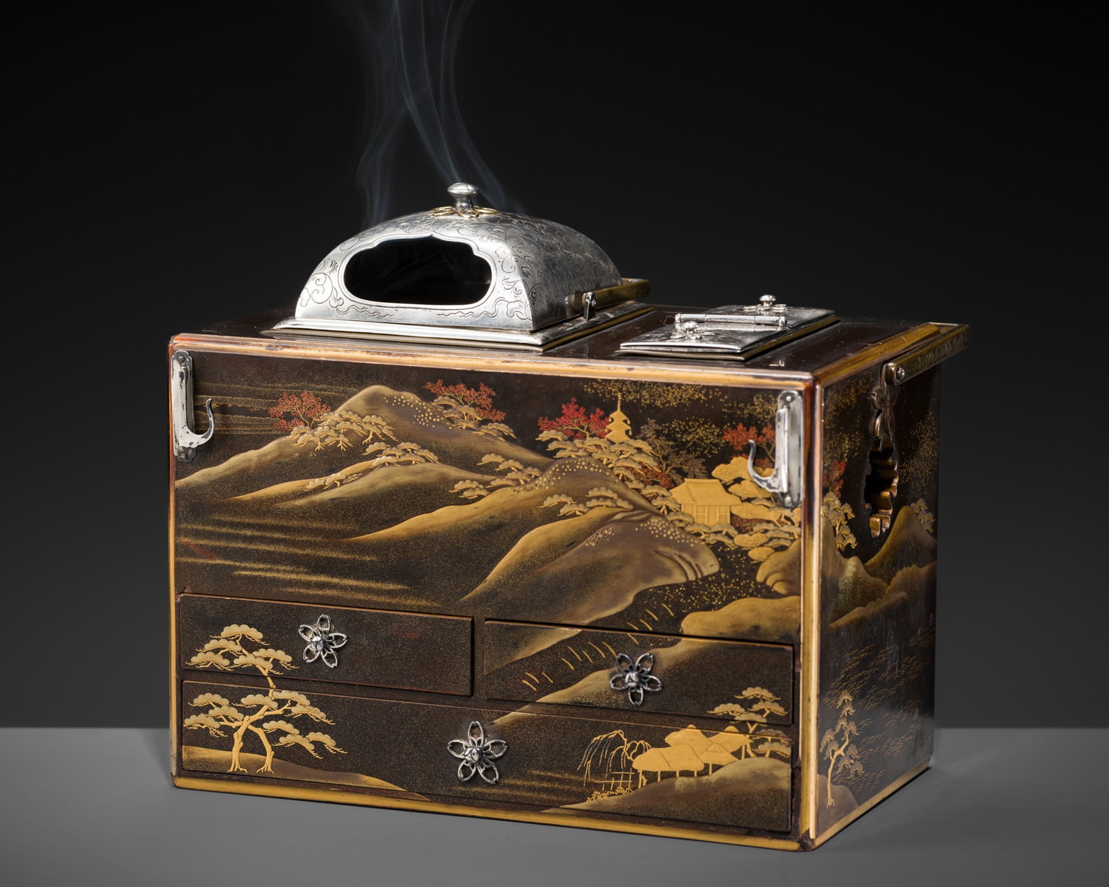 A FINE SILVER-FITTED LACQUER 'MOUNT FUJI' TABAKO-BON SMOKING SET: A FINE SILVER-FITTED LACQUER 'MOUNT FUJI' TABAKO-BON SMOKING SET Japan, 19th century, late Edo (1615-1868) to Meiji period (1868-1912) The portable box of rectangular form is fitted with a prominent o