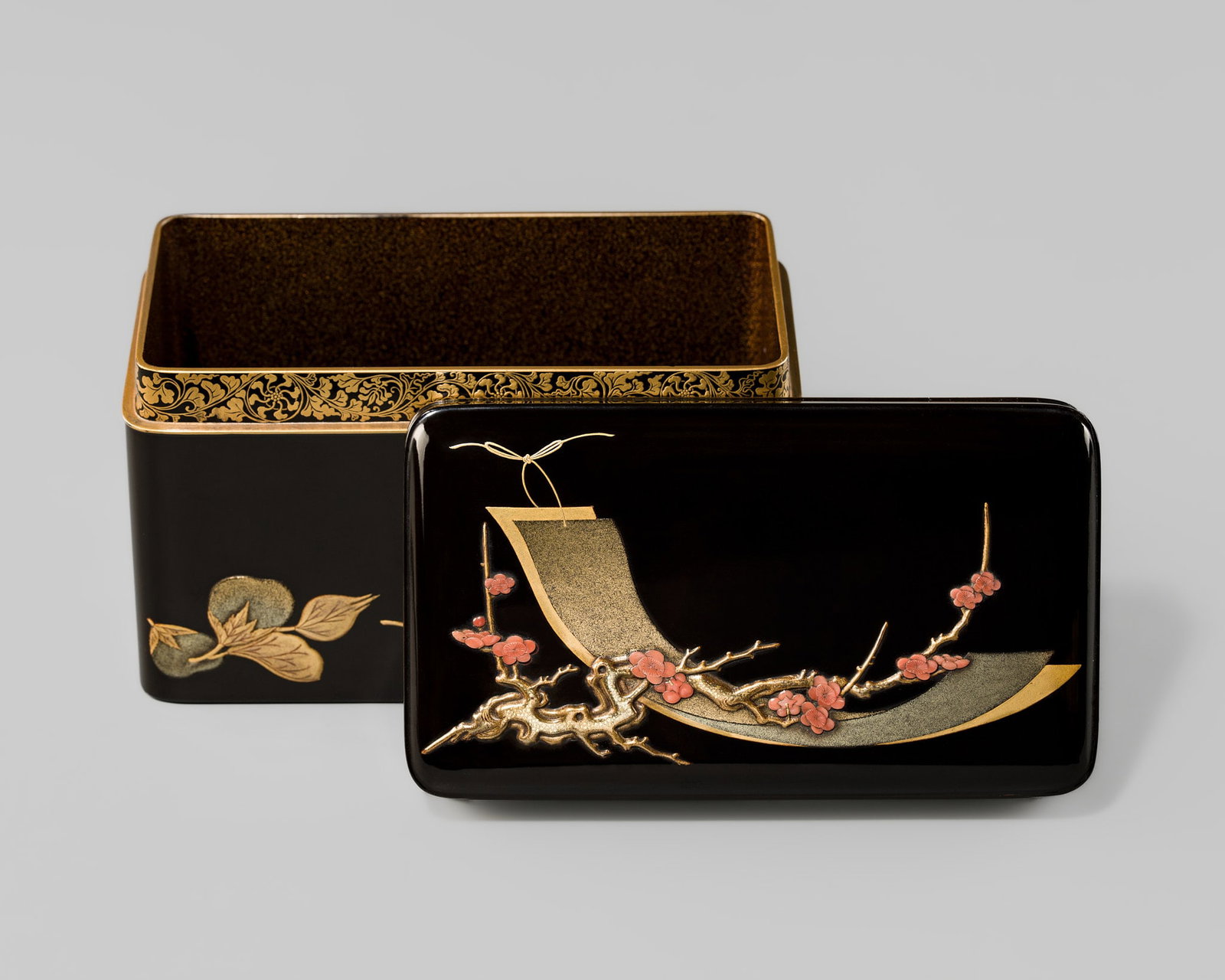 A RARE AND FINE CORAL-INLAID LACQUER 'BLOSSOMING PLUM AND TANZAKU' CHABAKO (TEA CEREMONY UTENSILS: A RARE AND FINE CORAL-INLAID LACQUER 'BLOSSOMING PLUM AND TANZAKU' CHABAKO (TEA CEREMONY UTENSILS BOX) Japan, 19th century Rectangular in form with rounded corners, the box features a slightly domed, 