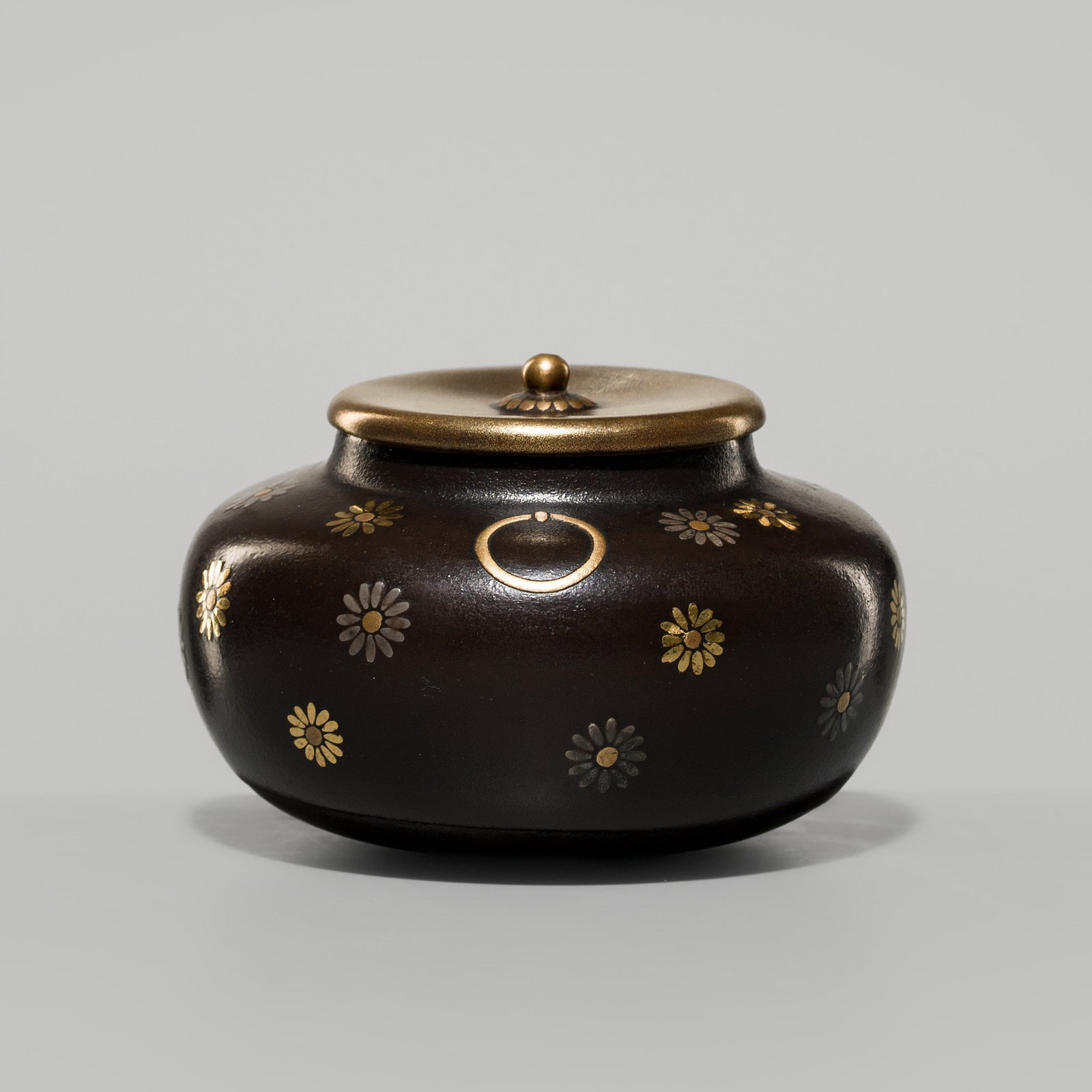 A FINE LACQUER 'CHRYSANTHEMUMS' NATSUME (TEA CADDY): A FINE LACQUER 'CHRYSANTHEMUMS' NATSUME (TEA CADDY) Japan, 19th century, late Edo (1615-1868) to Meiji period (1868-1912) Of pot form, bearing a rich brown ground, finely decorated with gold and silve