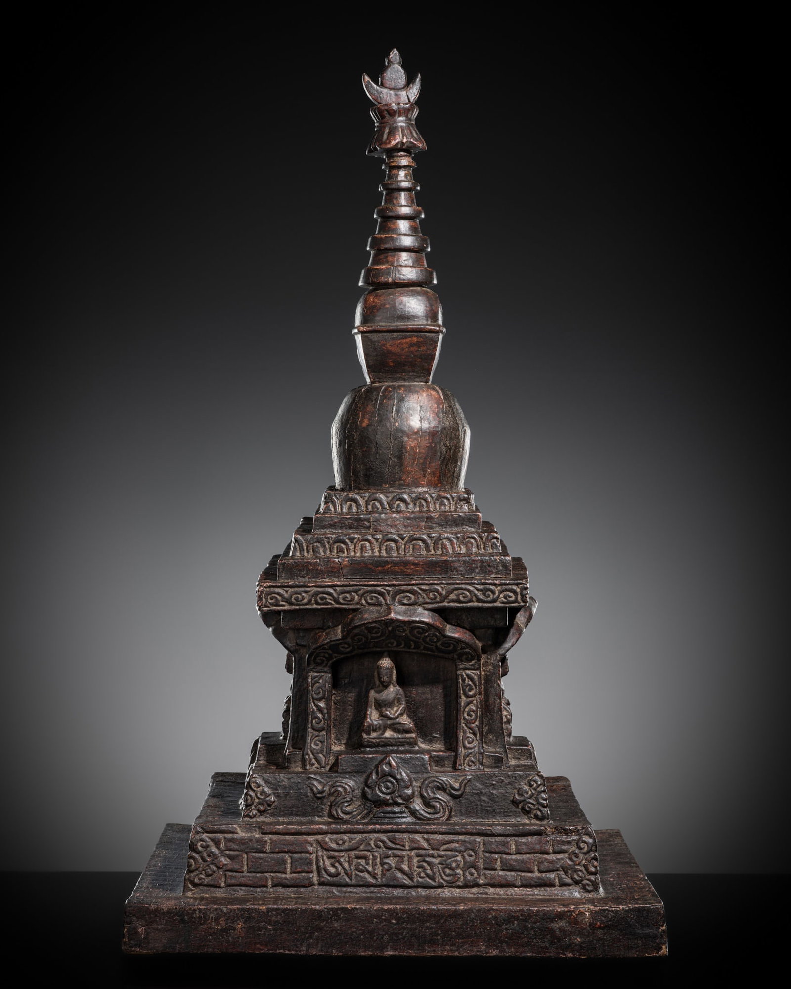 A LARGE CARVED AND LACQUERED WOOD 'FOUR BUDDHA' DIRECTIONAL STUPA, NEPAL, 18TH-19TH CENTURY (1 of 8)