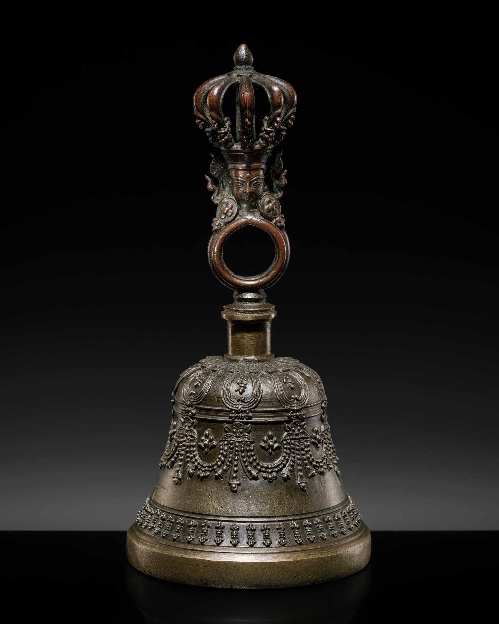A COPPER AND BRASS ALLOY RITUAL BELL, GHANTA, 18TH CENTURY AND LATER: A COPPER AND BRASS ALLOY RITUAL BELL, GHANTA, 18TH CENTURY AND LATER The domed-shaped bell is decorated at the shoulder with radiating lotus petals each containing a character, above a band of horizon