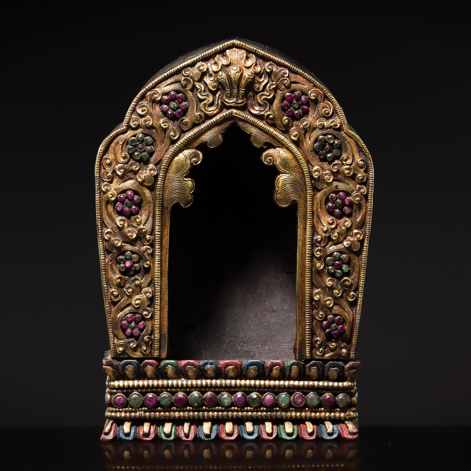 A GEMSTONE-INLAID GILT-COPPER REPOUSSÉ AND WOOD SHRINE, GAU, 19TH CENTURY: A GEMSTONE-INLAID GILT-COPPER REPOUSSÉ AND WOOD SHRINE, GAU, 19TH CENTURY Himalayan regions, Tibet or Nepal. The copper repoussé applications are finely chased and embossed, while the hardwo
