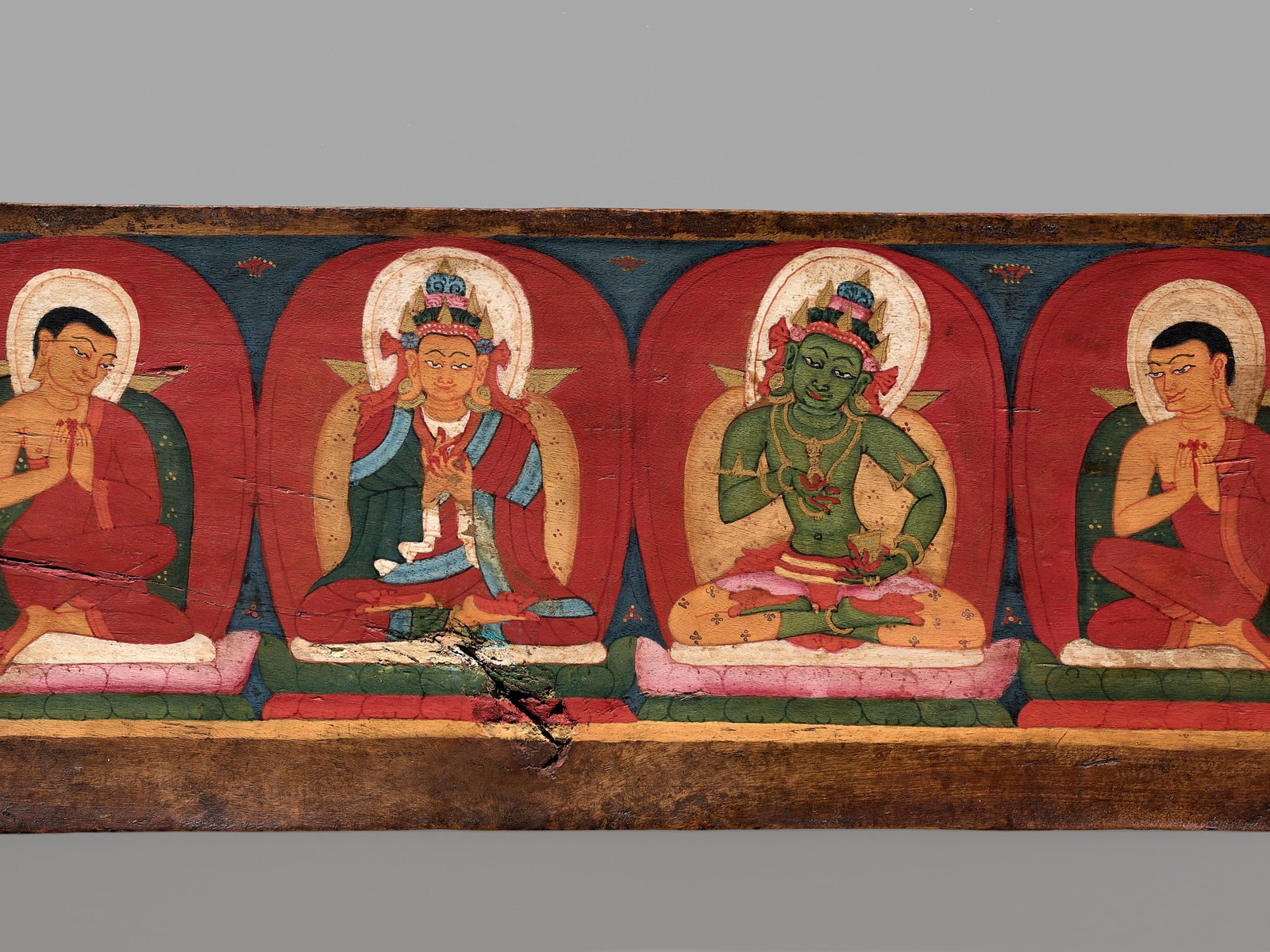 A PAINTED WOOD SUTRA COVER, TIBET, CIRCA 13TH CENTURY (1 of 14)