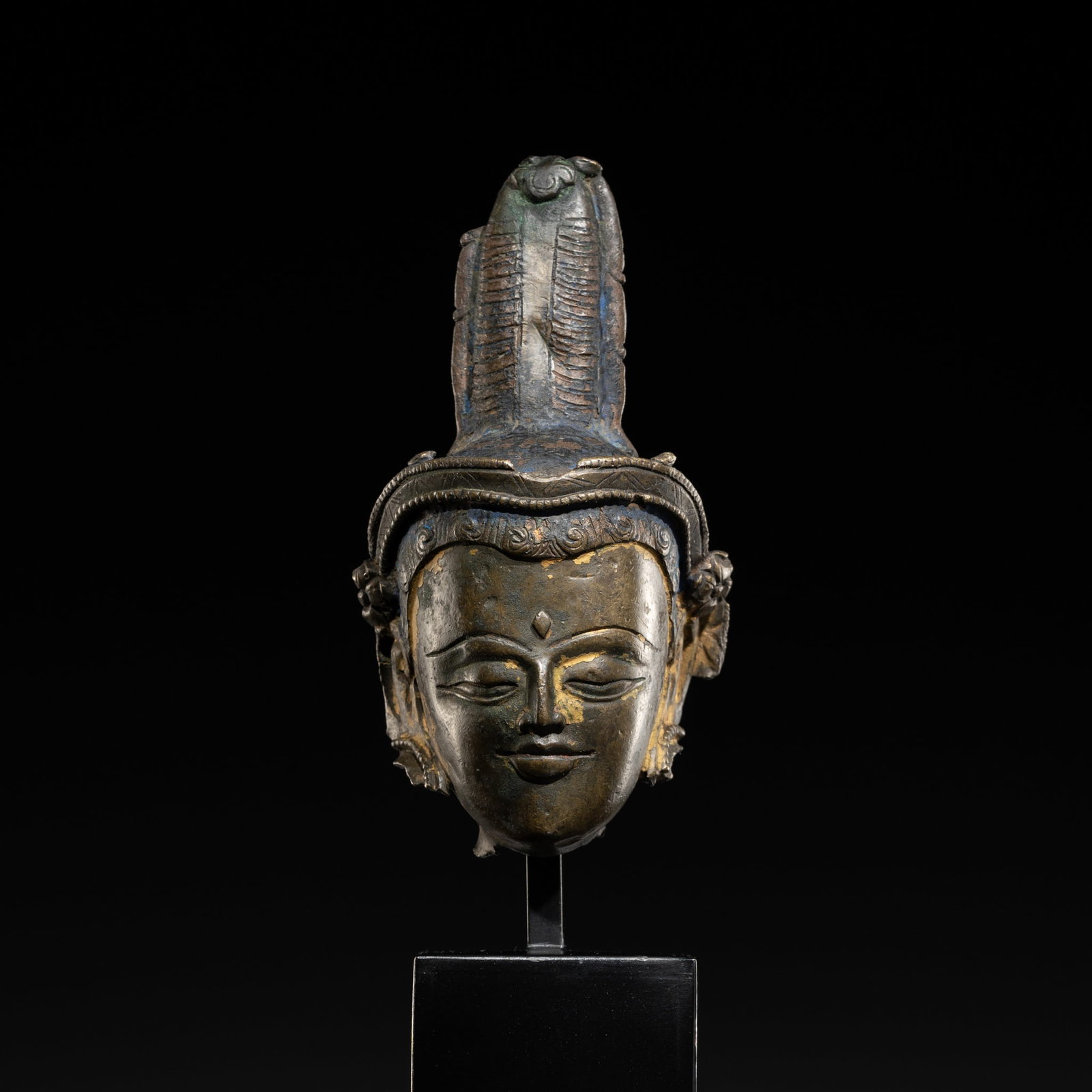 A RARE BRONZE HEAD OF A BODHISATTVA, TIBET, 11TH-12TH CENTURY: A RARE BRONZE HEAD OF A BODHISATTVA, TIBET, 11TH-12TH CENTURY Expert's note: The present head was once part of an early Tibetan figure of relatively large size, originally standing at about 50 cm. Com
