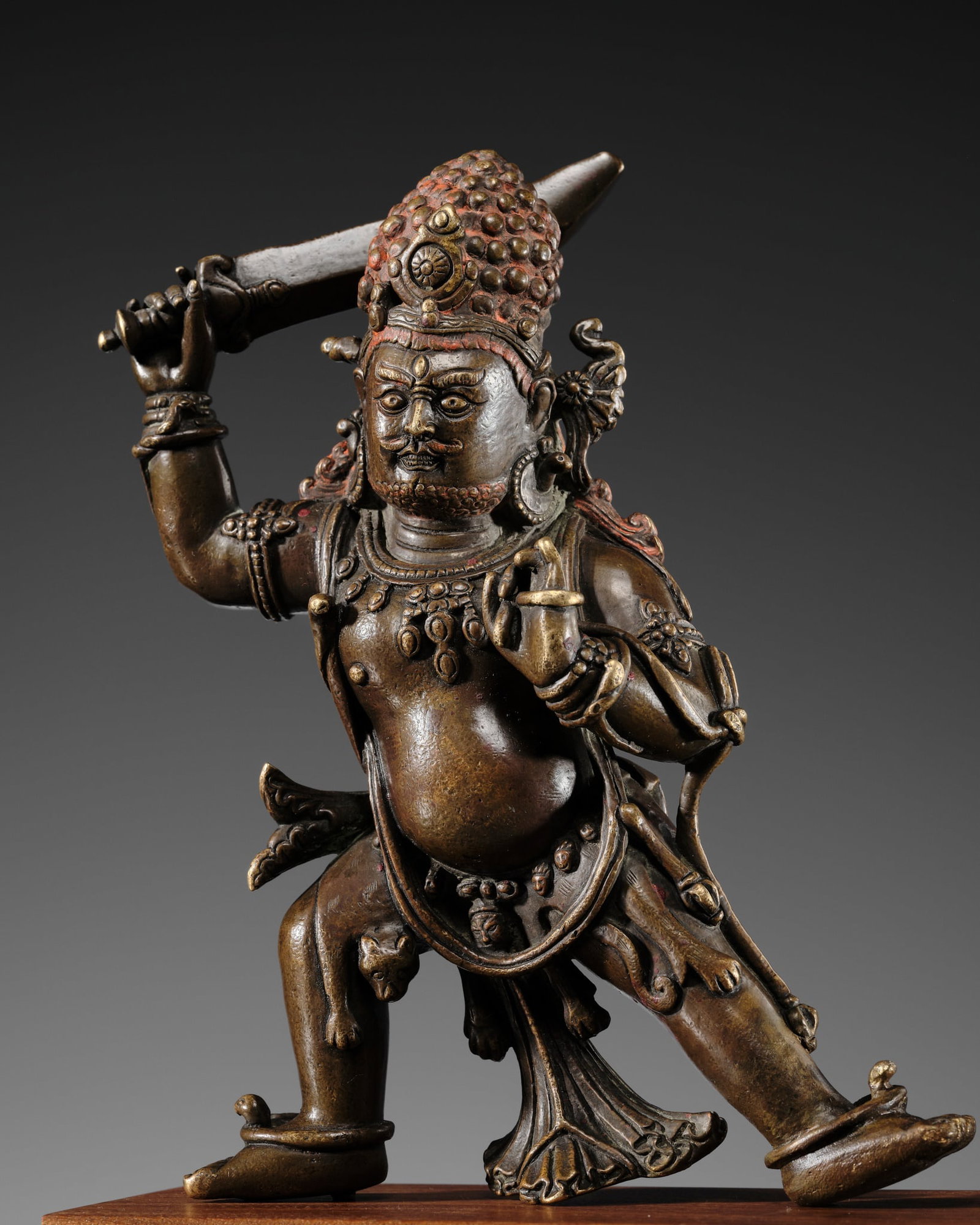 A BRONZE FIGURE OF ACHALA, TIBET, 16TH-17TH CENTURY: † A BRONZE FIGURE OF ACHALA, TIBET, 16TH-17TH CENTURY Finely cast standing in alidhasana, brandishing a sword above his head, the left hand in karana mudra with a tassel of a lasso gently wrappe