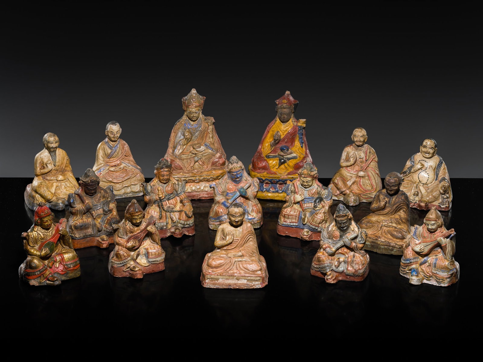 A GROUP OF SIXTEEN POLYCHROMED LACQUERED CLAY FIGURES, TIBET, CIRCA 18TH CENTURY (1 of 15)