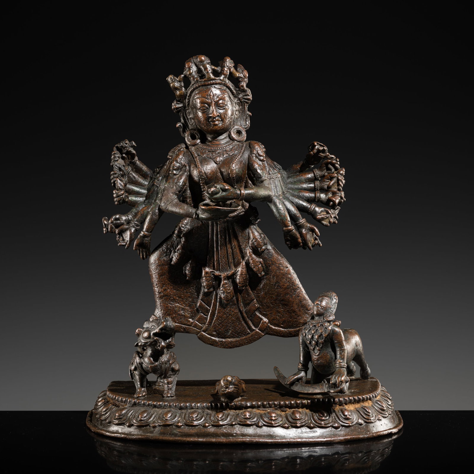 A LARGE BRONZE FIGURE OF DURGA MAHISHASURAMARDINI, NEPAL, 18TH CENTURY: A LARGE BRONZE FIGURE OF DURGA MAHISHASURAMARDINI, NEPAL, 18TH CENTURY The multi-armed goddess beautifully modeled in alidhasana with one foot atop her lion mount and the other above the decapitated b