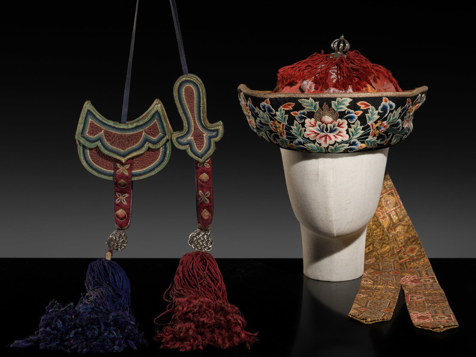 AN EMBROIDERED SILK OFFICIAL'S HAT, BHUTAN, 19TH-EARLY 20TH CENTURY: AN EMBROIDERED SILK OFFICIAL'S HAT, BHUTAN, 19TH-EARLY 20TH CENTURY Of domed shape, the upturned brim embroidered with lotus vines on a black silk ground, surrounding a domed crown finely woven in sha