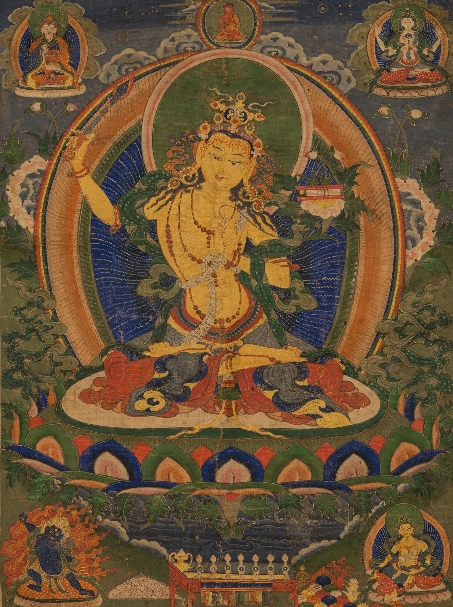 A THANGKA DEPICTING MANJUSHRI, TIBET OR BHUTAN, 18TH-19TH CENTURY: A THANGKA DEPICTING MANJUSHRI, TIBET OR BHUTAN, 18TH-19TH CENTURY Gold and distemper on cloth. Mounted in an unusually fine silk and gold thread brocade hanging. The Bodhisattva of Wisdom with golden-