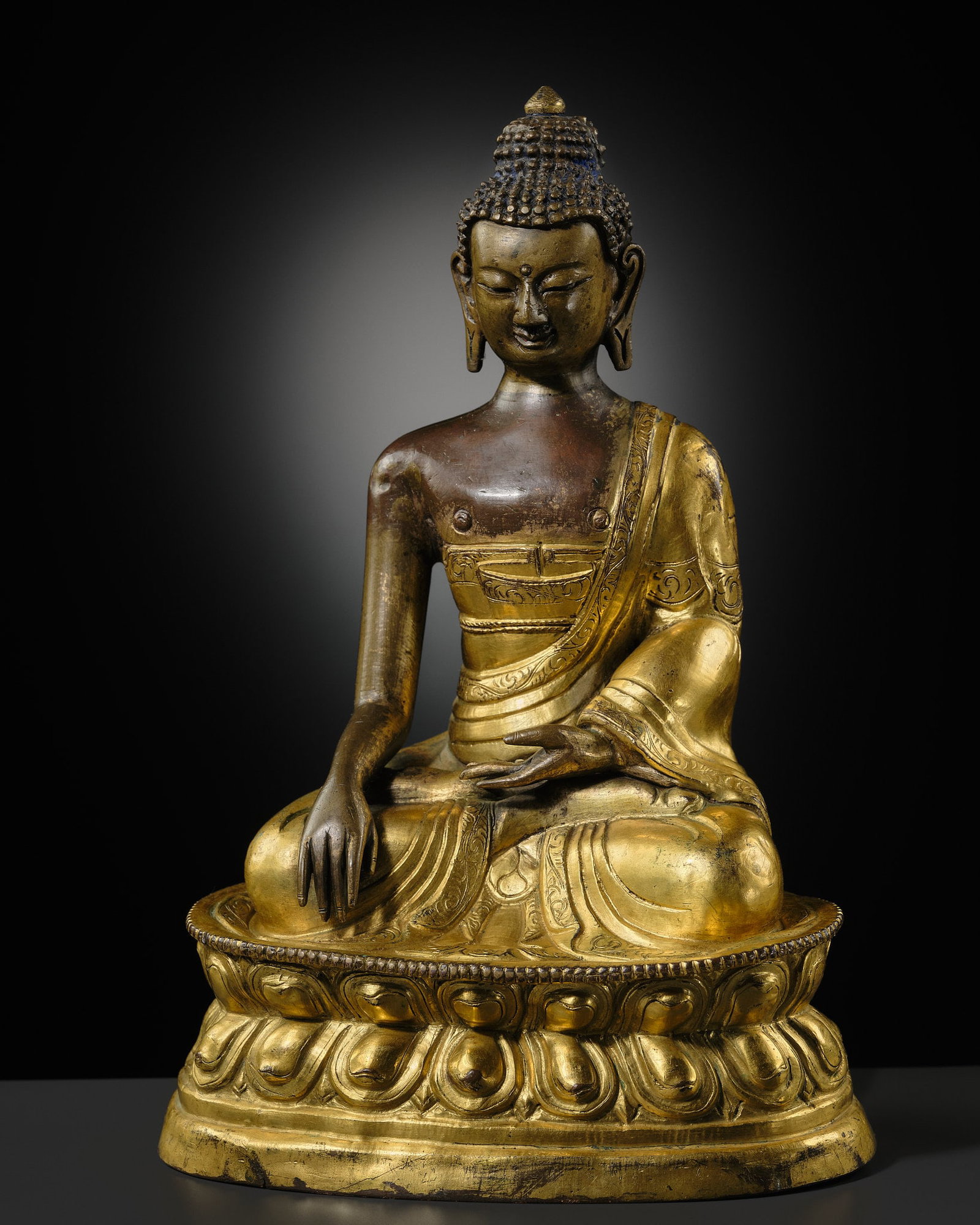 A GILT-BRONZE REPOUSSÉ FIGURE OF BUDDHA SHAKYAMUNI, INNER MONGOLIA, DOLONNOR MONASTERY, 18TH (1 of 14)
