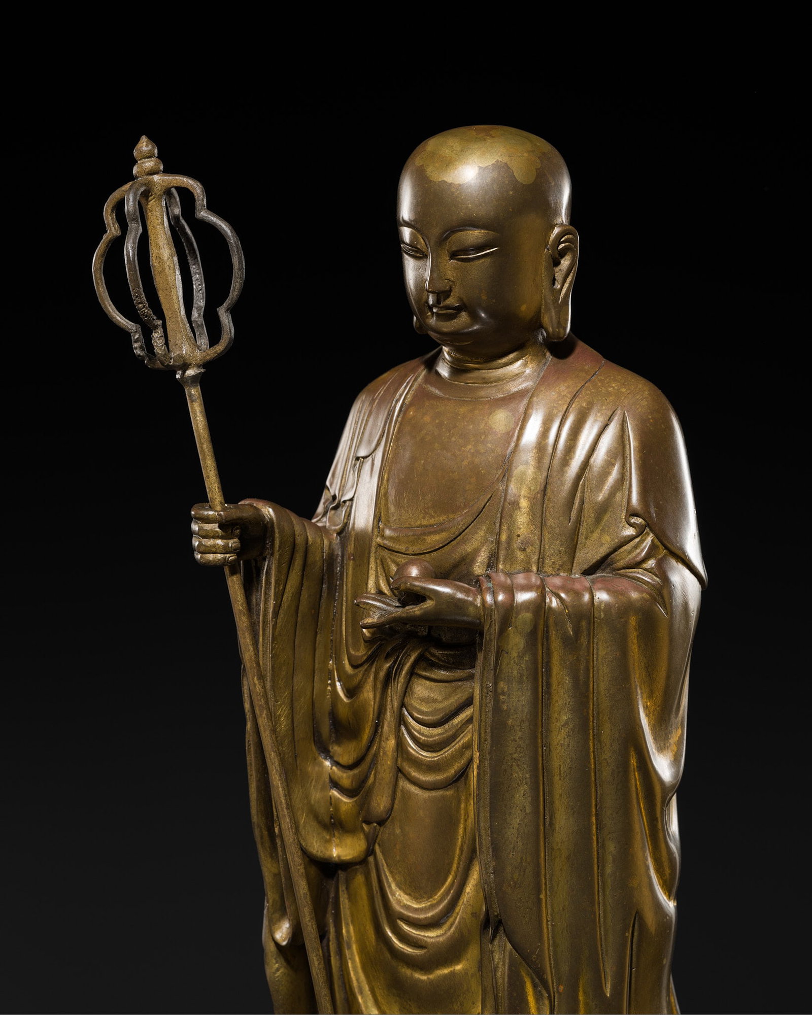 A FINE GILT-BRONZE FIGURE OF KSITIGARBHA (TI TSANG), c. 1900s: A FINE GILT-BRONZE FIGURE OF KSITIGARBHA (TI TSANG), c. 1900s China, late Qing Dynasty (1644-1912) to Republic period (1912-1949). Finely and heavily cast, the figure stands atop a double-lotus pedest