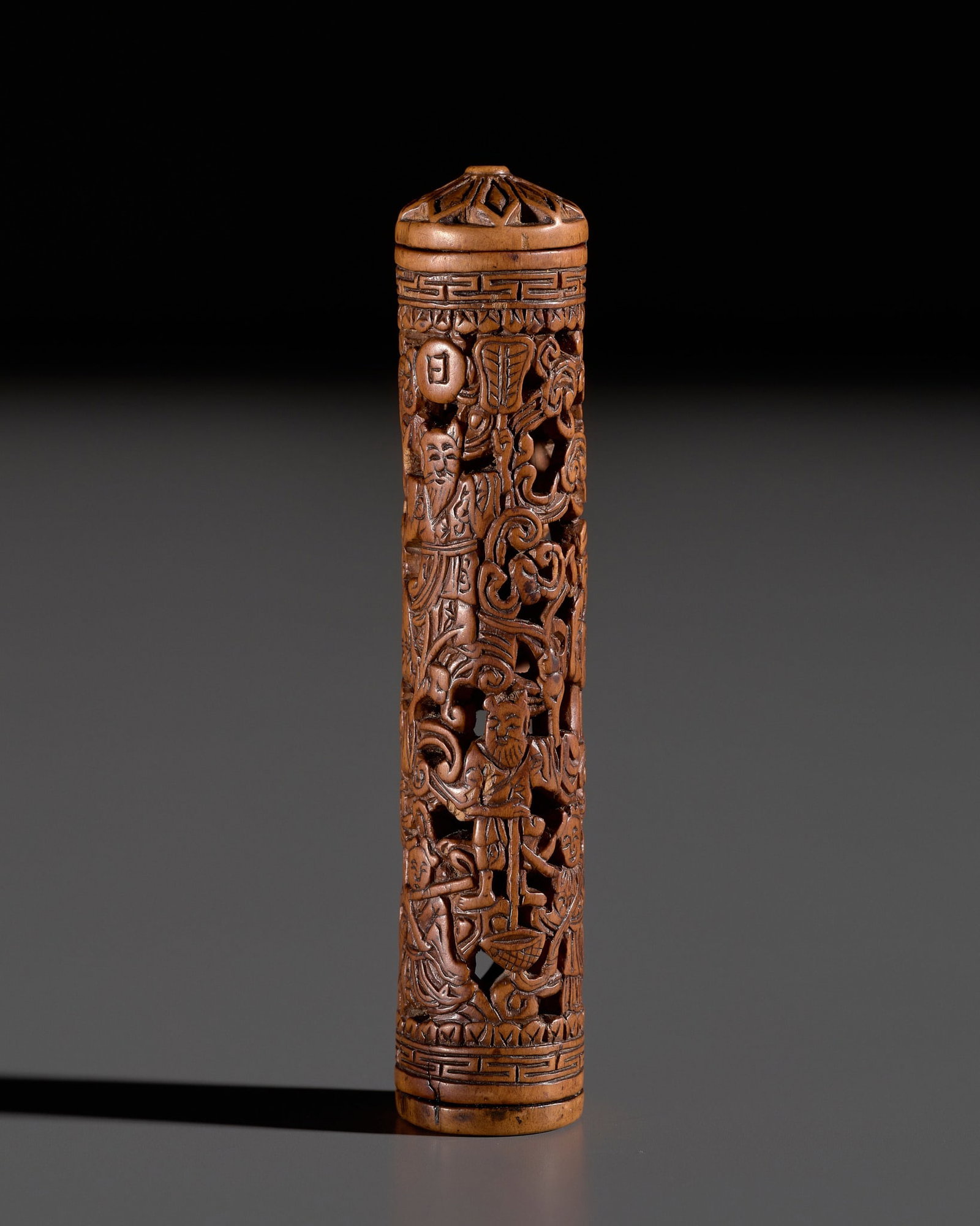 A SMALL CARVED AND RETICULATED BOXWOOD 'XIWANGMU AND THE EIGHT IMMORTALS' PARFUMIER, QING DYNASTY: † A SMALL CARVED AND RETICULATED BOXWOOD 'XIWANGMU AND THE EIGHT IMMORTALS' PARFUMIER, QING DYNASTY China, 1644-1912. Of cylindrical form, carved and pierced with a lively scene featuring the Qu