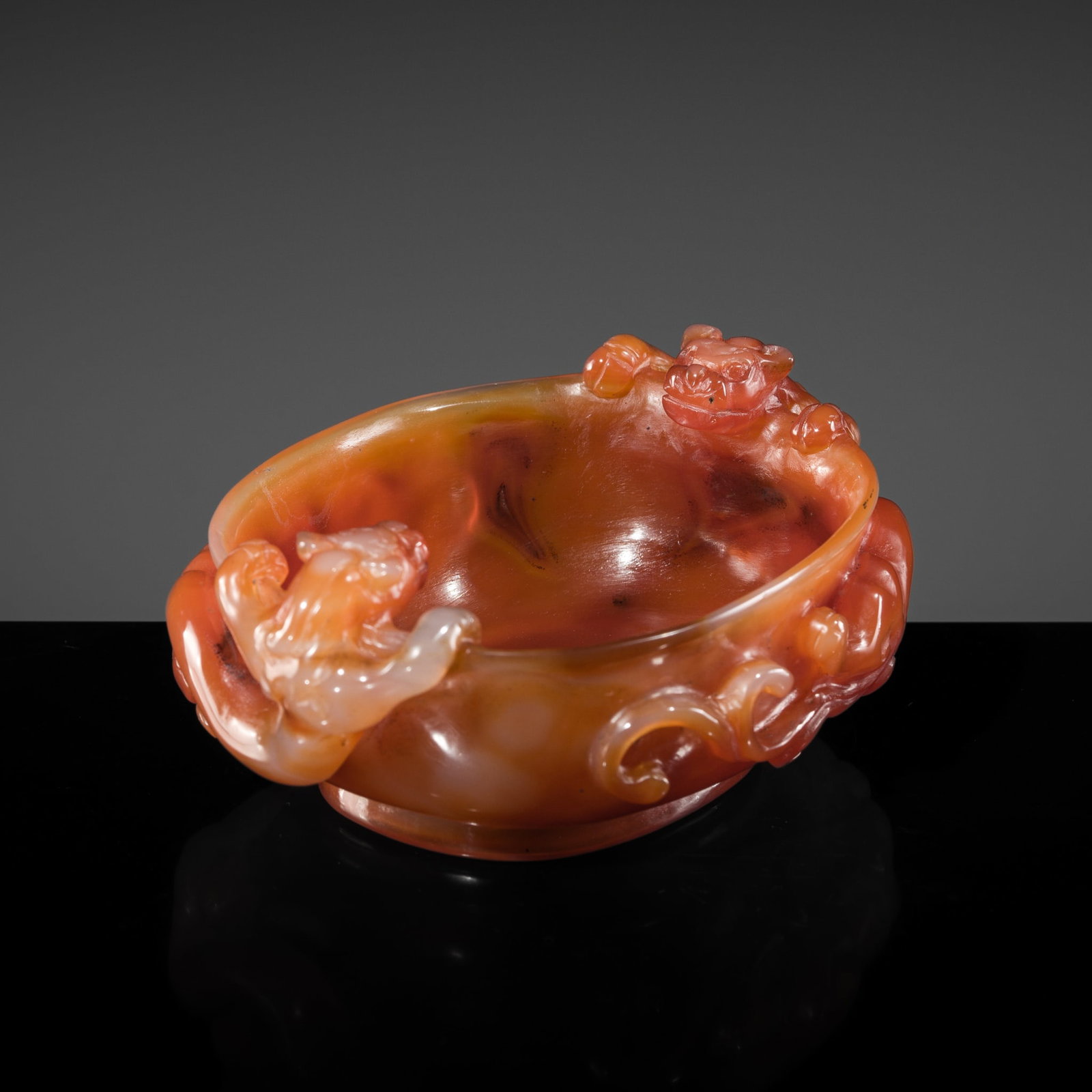 AN AGATE 'TWIN CHILONG' BRUSH WASHER, QING DYNASTY: AN AGATE 'TWIN CHILONG' BRUSH WASHER, QING DYNASTY China, 1644-1912. Of oval form, with deep, rounded sides supported on a short, subtly flared foot and rising to a slightly everted rim. Finely carved