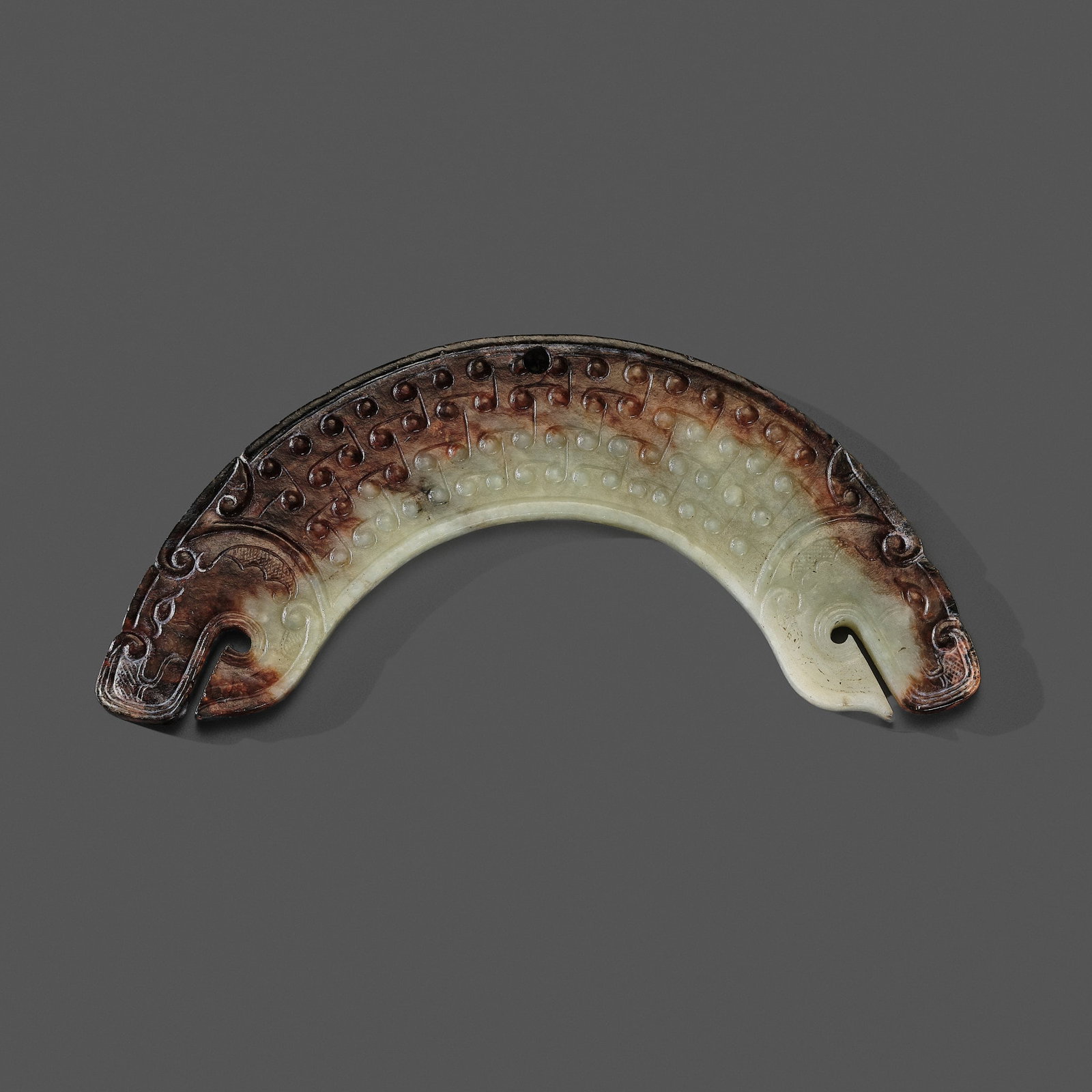 A PALE CELADON AND DARK RUSSET JADE 'DOUBLE DRAGON' PENDANT, HUANG, LATE EASTERN ZHOU (1 of 17)