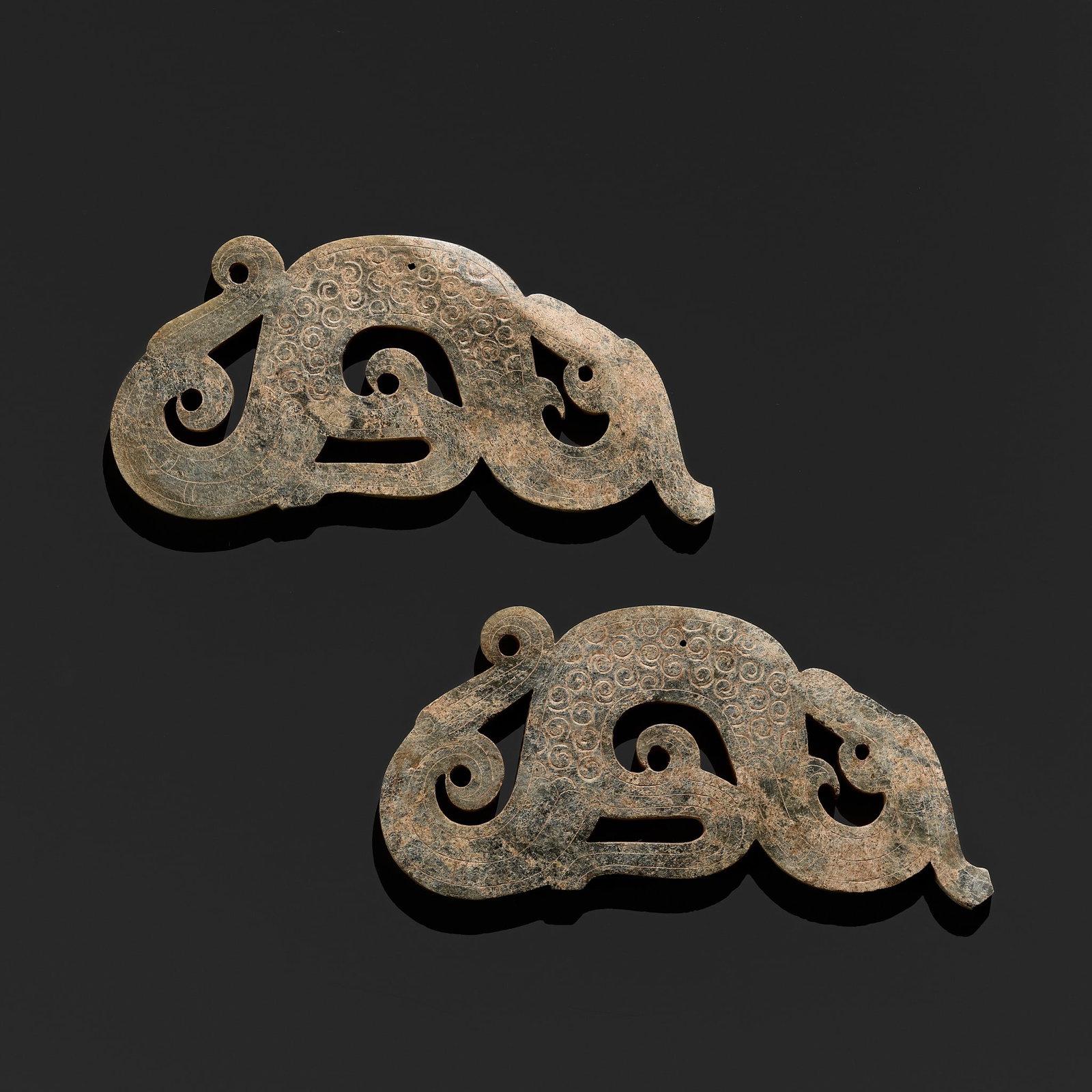 A FINE PAIR OF GREEN JADE 'DRAGON' SILHOUETTE PENDANTS, WARRING STATES PERIOD (1 of 14)