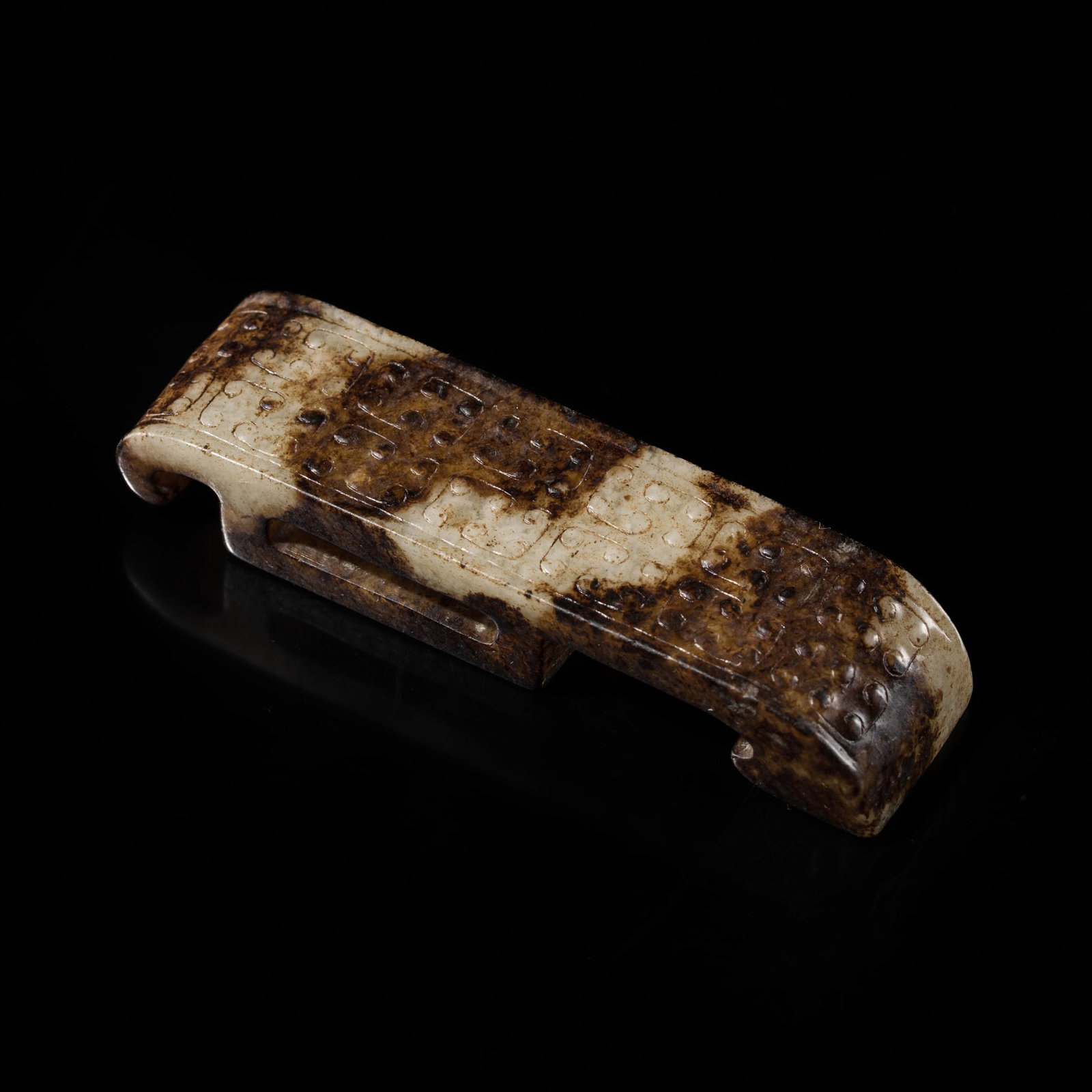 A WHITE AND BLACK JADE SCABBARD SLIDE, WARRING STATES PERIOD-WESTERN HAN DYNASTY (1 of 12)