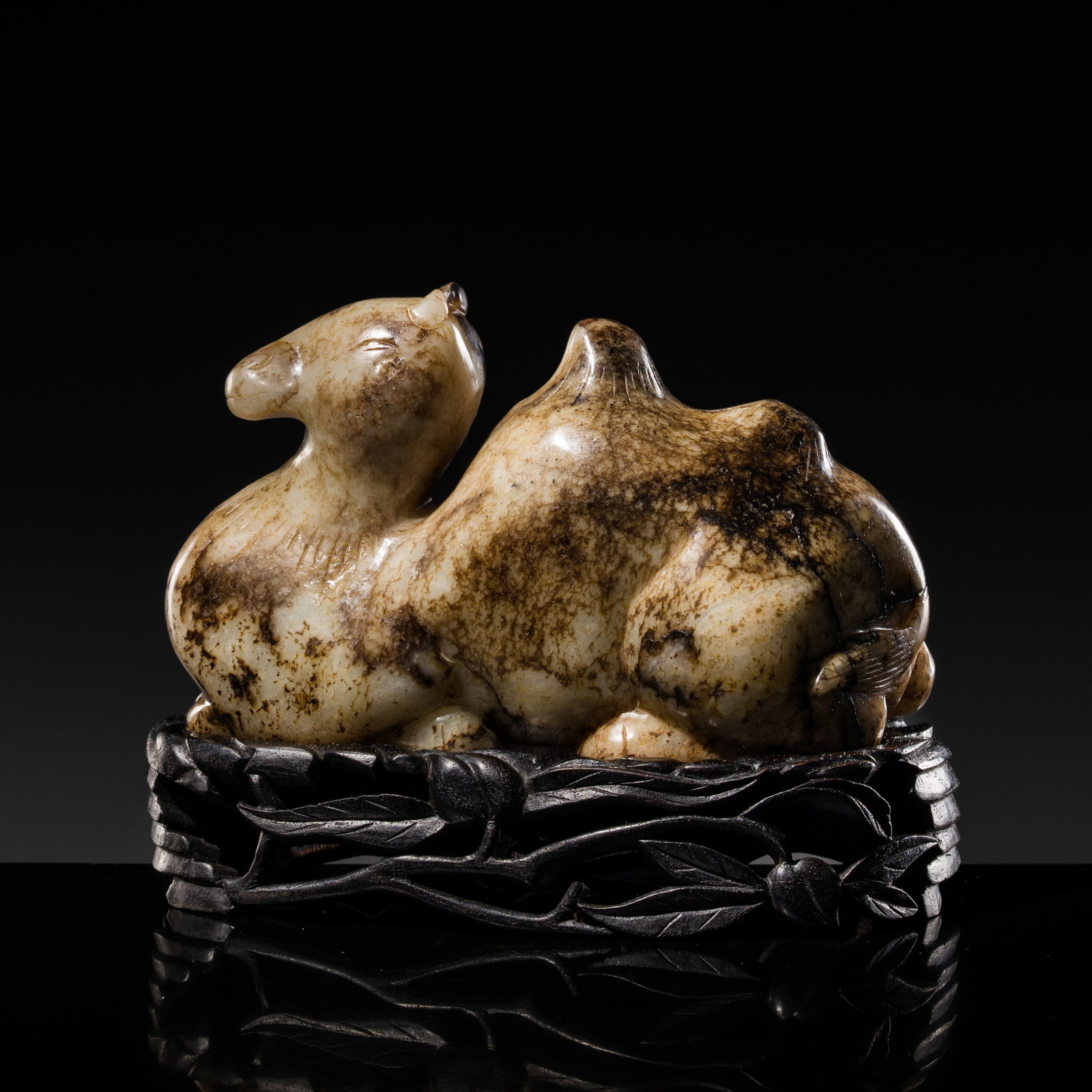 A GRAY AND BLACK JADE FIGURE OF A RECUMBENT CAMEL, MING DYNASTY OR EALIER (1 of 15)