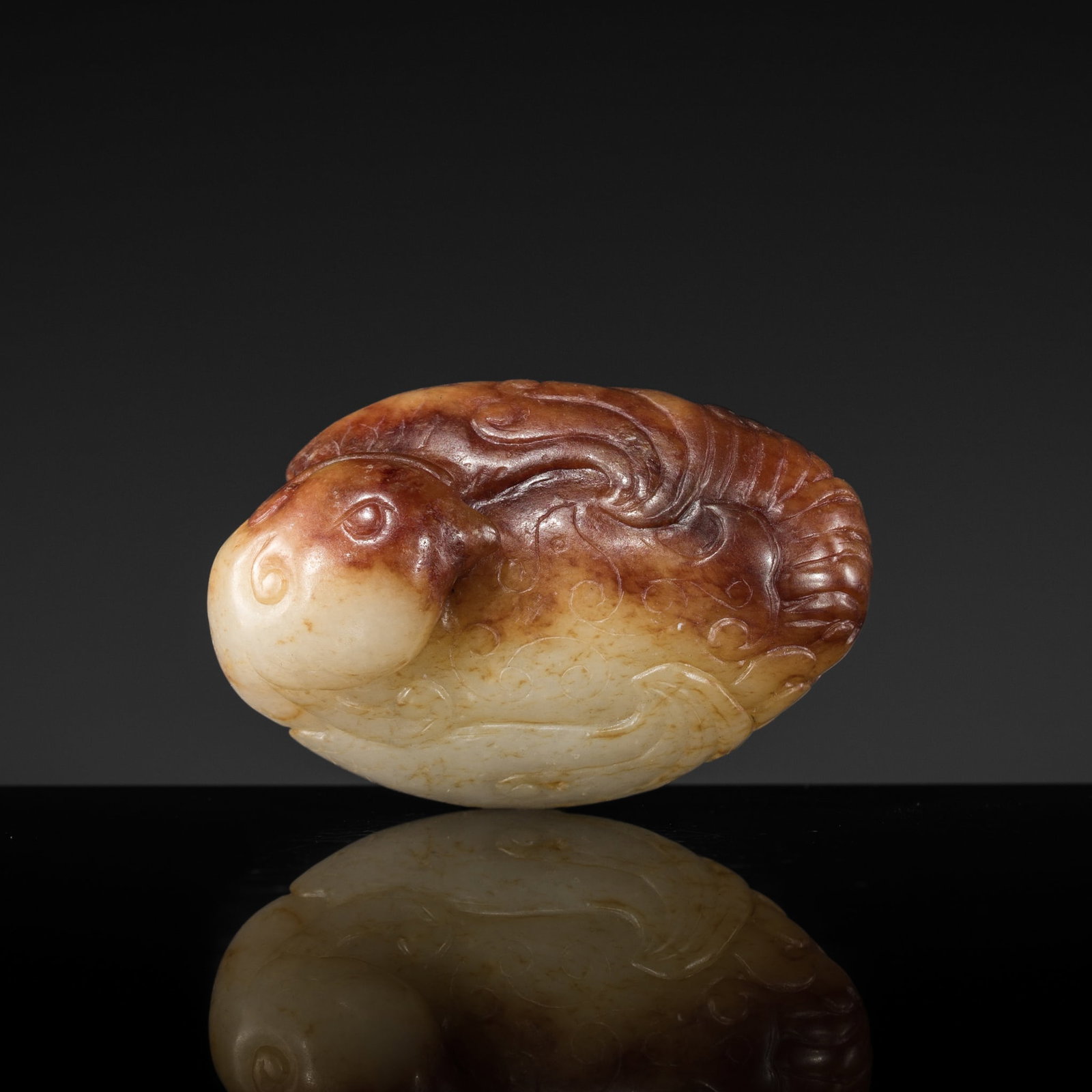 A WHITE AND RUSSET JADE 'MYTHICAL BIRD' PENDANT, MING DYNASTY (1 of 12)