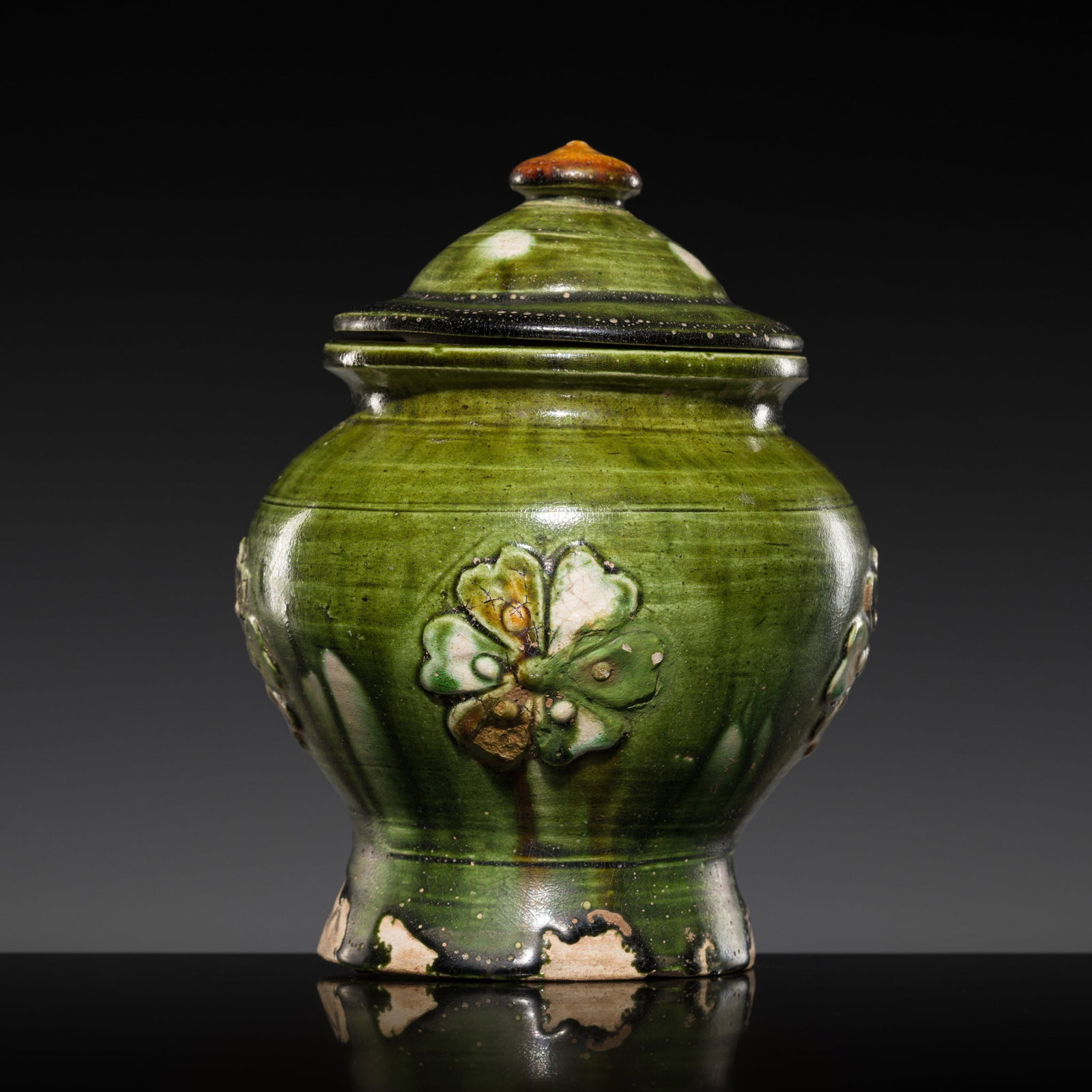 A RARE APPLIQUÉ-DECORATED SANCAI GLAZED JAR AND COVER, TANG DYNASTY (1 of 12)