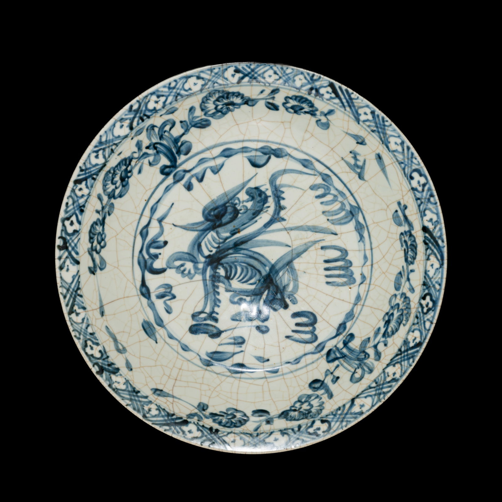A LARGE SWATOW BLUE AND WHITE 'QILIN' CHARGER, MING DYNASTY: A LARGE SWATOW BLUE AND WHITE 'QILIN' CHARGER, MING DYNASTY China, 16th century. The deep sides raised on a short tapering foot and rising to an everted rim, boldly painted in lighter and darker shade