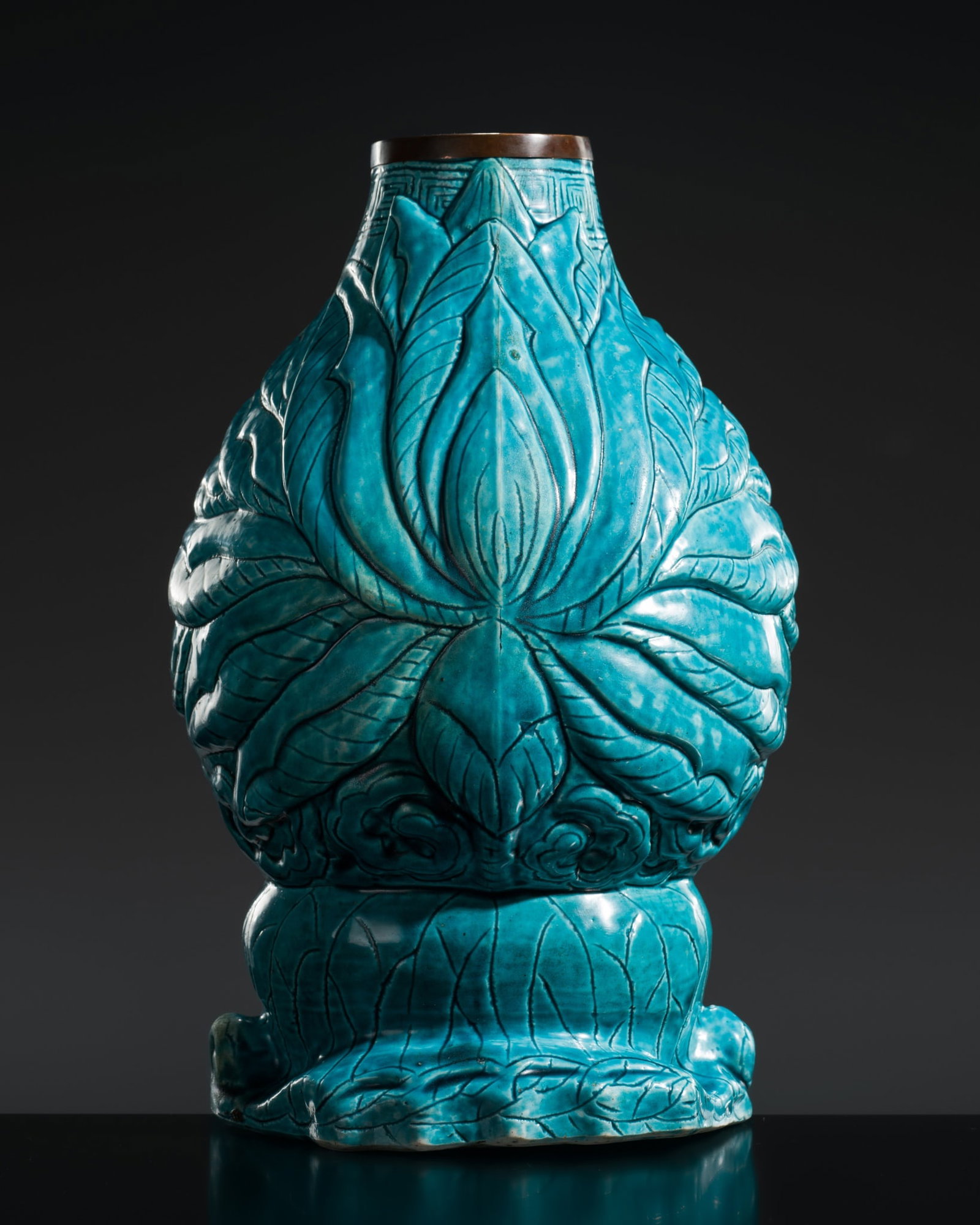 AN EXTREMELY RARE TURQUOISE-GLAZED 'LOTUS' WALL VASE, WANLI PERIOD: AN EXTREMELY RARE TURQUOISE-GLAZED 'LOTUS' WALL VASE, WANLI PERIOD China, 1572-1620. Well potted with a globular body supported on a rounded slightly recessed base to a narrow mouth with a copper moun