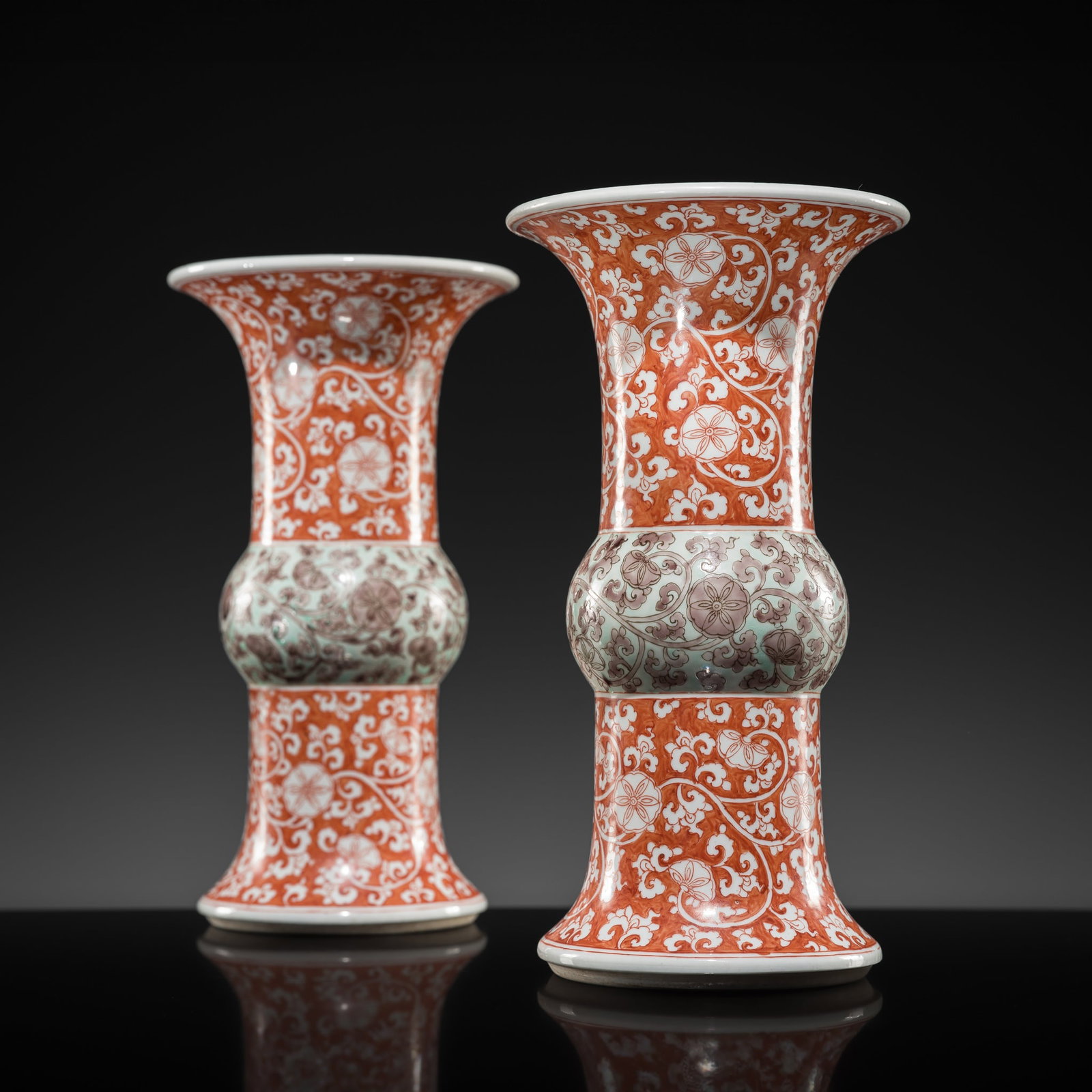 A PAIR OF CORAL-RED, GREEN AND AUBERGINE-DECORATED BEAKER VASES, GU, KANGXI PERIOD: A PAIR OF CORAL-RED, GREEN AND AUBERGINE-DECORATED BEAKER VASES, GU, KANGXI PERIOD China, 1662-1722. Finely potted, each with a spreading foot rising to a bulbous mid-section and a tall cylindrical ne